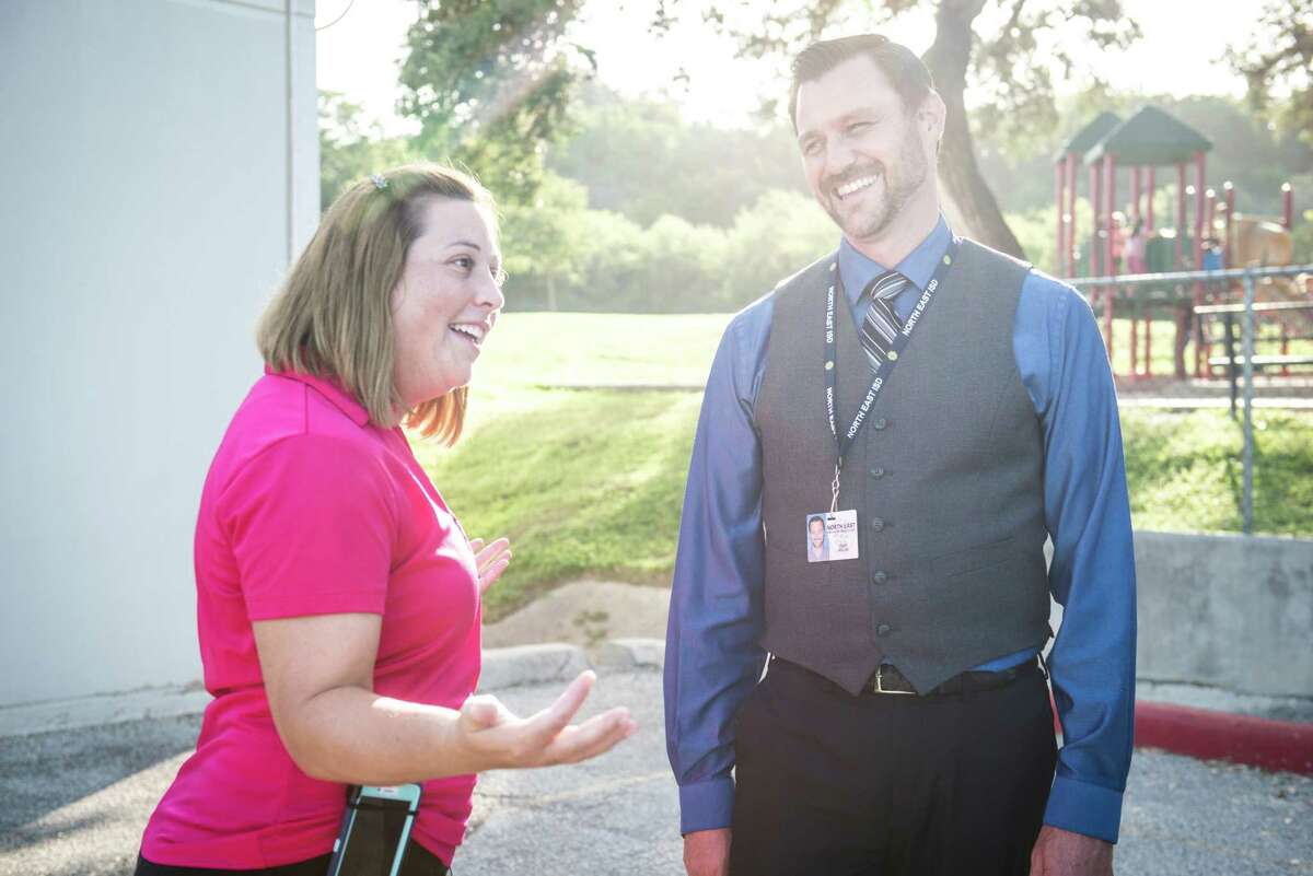 Diane Treviño of Hidden Forest Elementary School speaks with Principal Cody Miller after being surprised with the award.