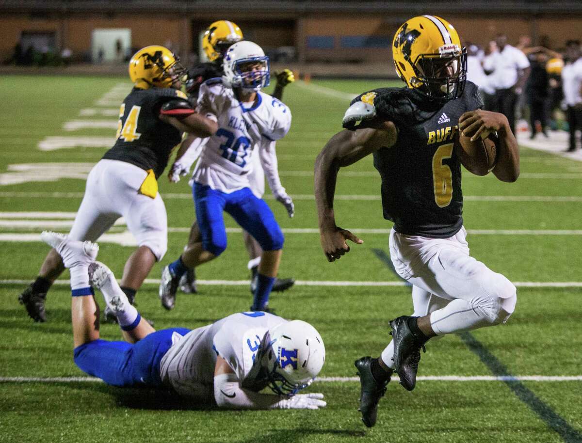 Fort Bend Marshall running back Antonio Brooks (6) runs past Klein linebacker Javon Roashe (32) for a 5-yard touchdown run, setting up a game-winning 2-point conversion, in overtime of a non-district high school football game at Hall Stadium on Thursday, Sept. 8, 2016, in Missouri City. Marshall beat Klein 32-31.