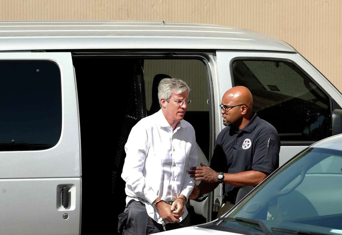 Charles Banks is transported to federal court after he turned himself in on federal wire fraud charges alleging that he misled Tim Duncan into making certain investments.