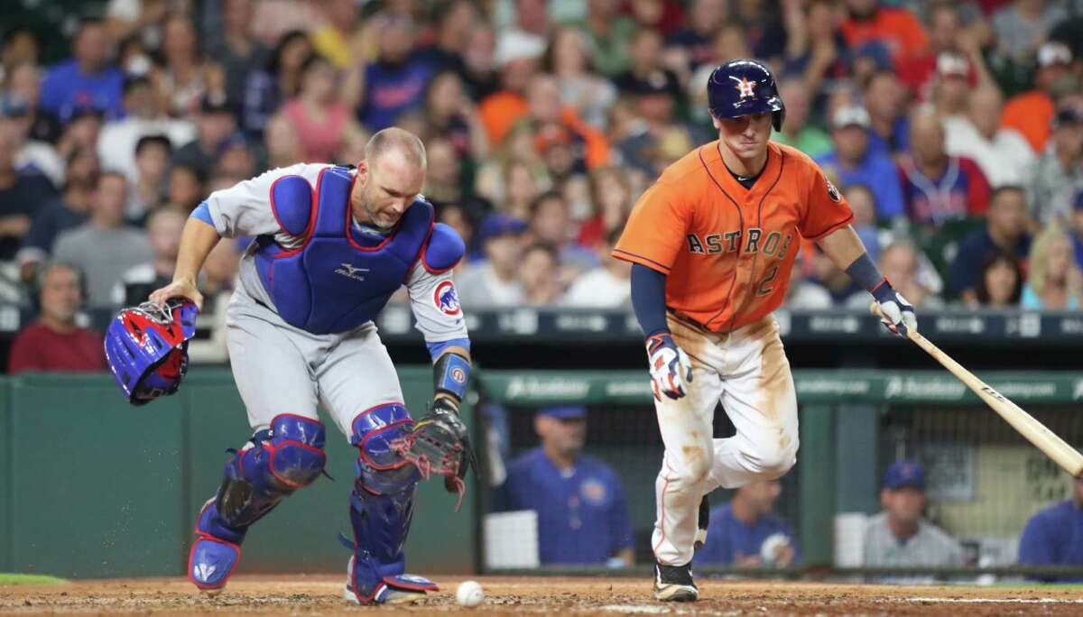 Chicago Cubs catcher David Ross (3) filed a ball infant of Houston Astros third baseman Alex Bregman (2) during an MLB game at Minute Maid Park, Friday, Sept. 9, 2016 in Houston.