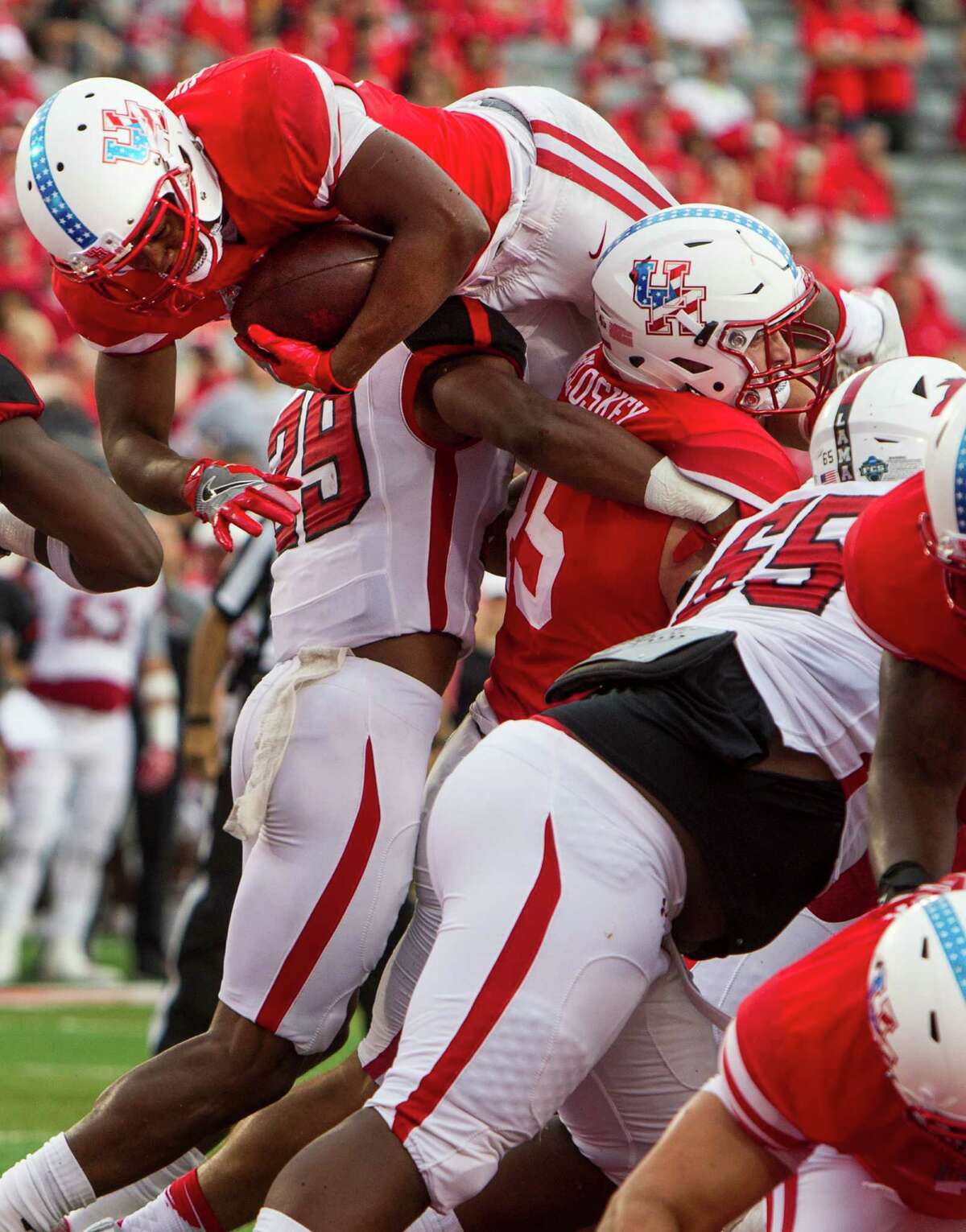 Houston running back Kevin Justice (32) dives over the goal line for a 1-yard touchdown run against Lamar during the first quarter of an NCAA football game at TDECU Stadium on Saturday, Sept. 10, 2016, in Houston.