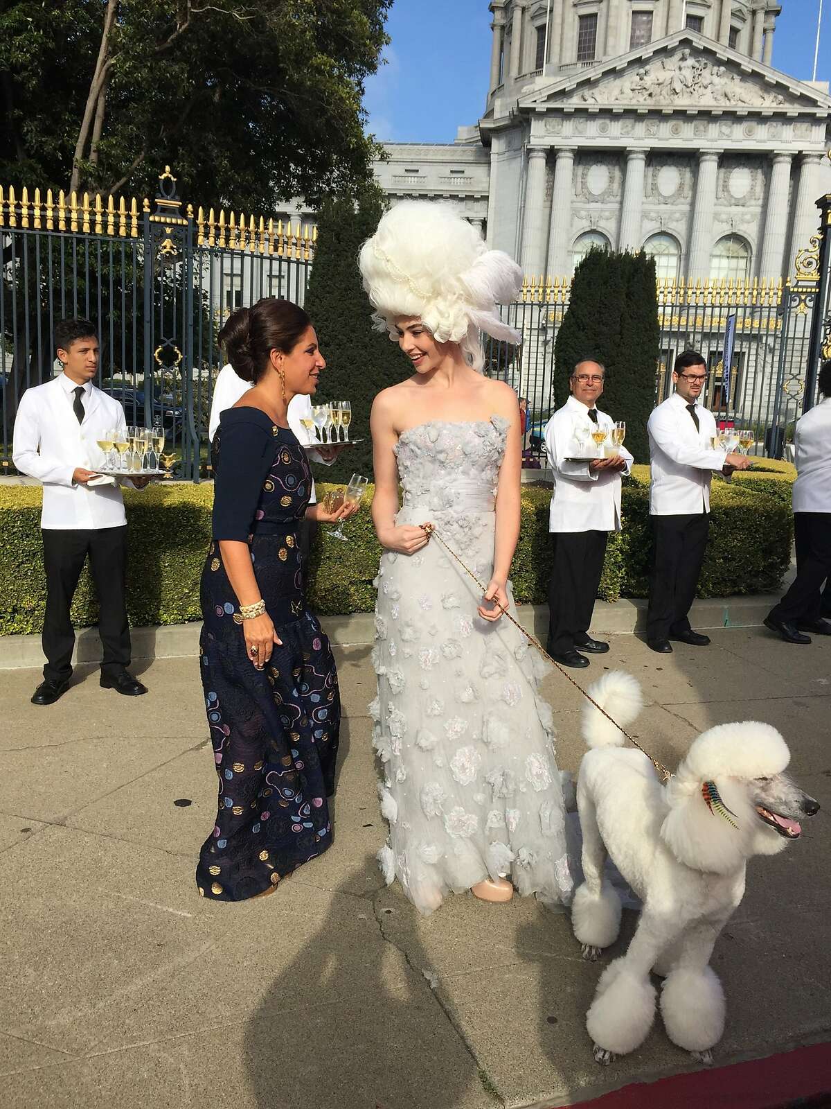 Lisa Grotts greets model with poodle at Opera opening Photo: John Grotts/Special to The Chronicle
