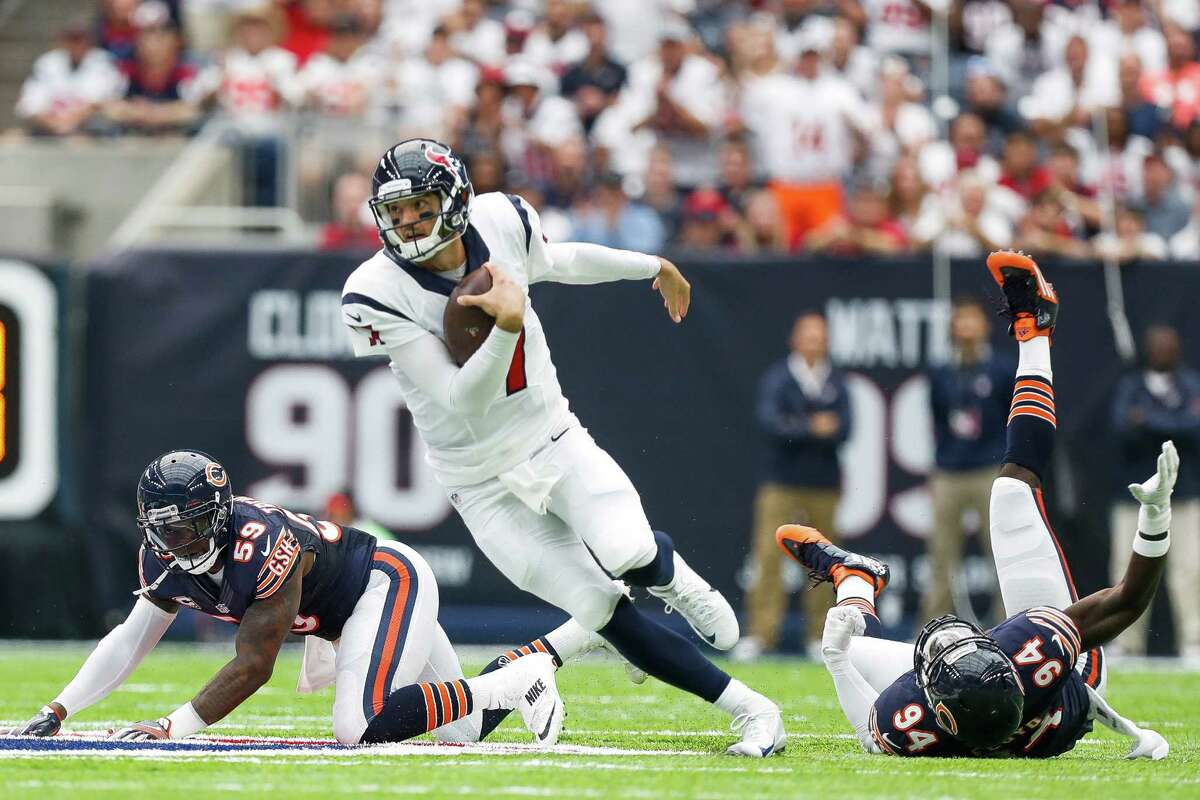 Houston Texans quarterback Brock Osweiler (17) runs past Chicago Bears linebacker Danny Trevathan (59) and outside linebacker Leonard Floyd (94) during the first quarter of an NFL game at NRG Stadium,Sunday, Sept. 11, 2016 in Houston.