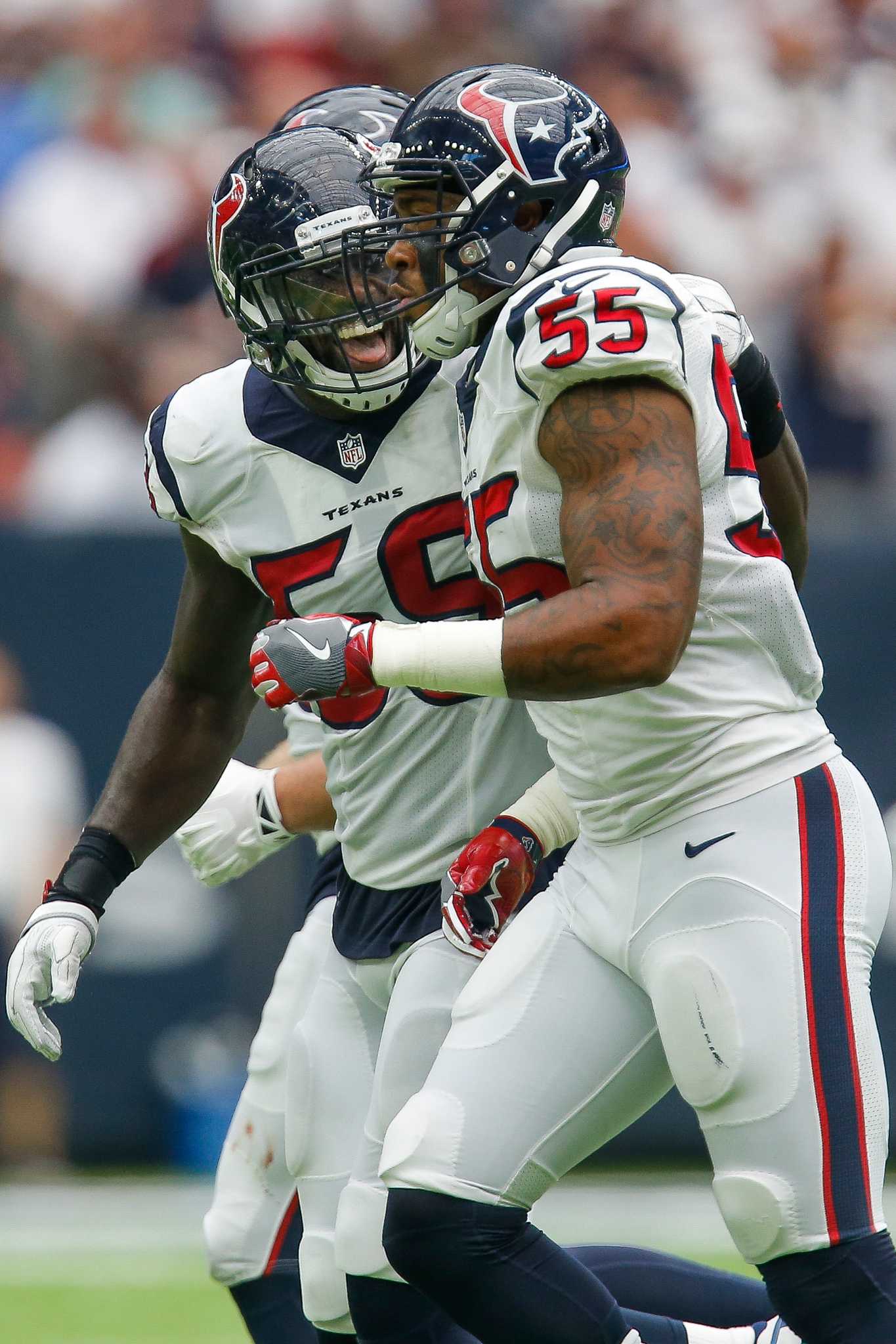 Washington Redskins quarterback Robert Griffin III (10) talks to Houston  Texans inside linebacker Brian Cushing (56) and defensive end J.J. Watt  (99) during the fourth quarter of an NFL football game Sunday