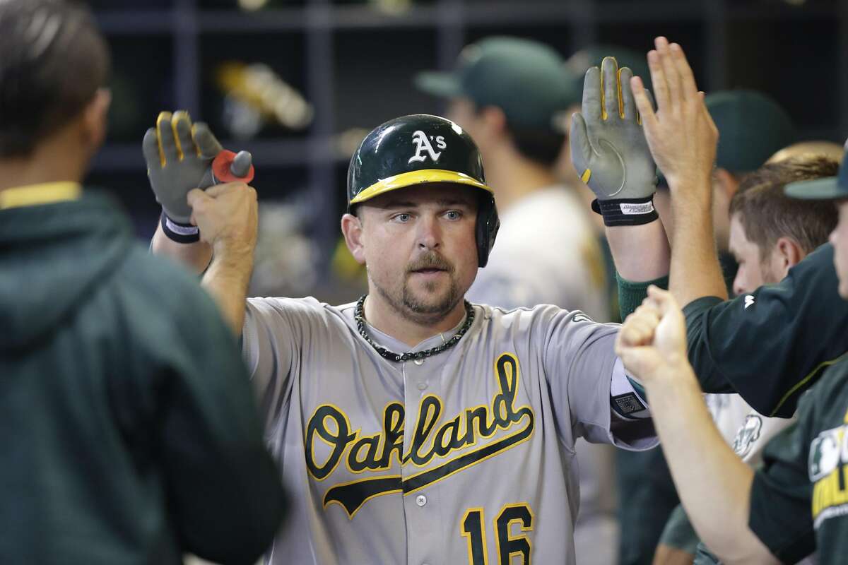 MILWAUKEE, WI - JUNE 07: Billy Butler #16 of the Oakland Athletics celebrates in the dugout after hitting a two run homer during the seventh inning of the Interleague game against the Milwaukee Brewers at Miller Park on June 07, 2016 in Milwaukee, Wisconsin. (Photo by Mike McGinnis/Getty Images)