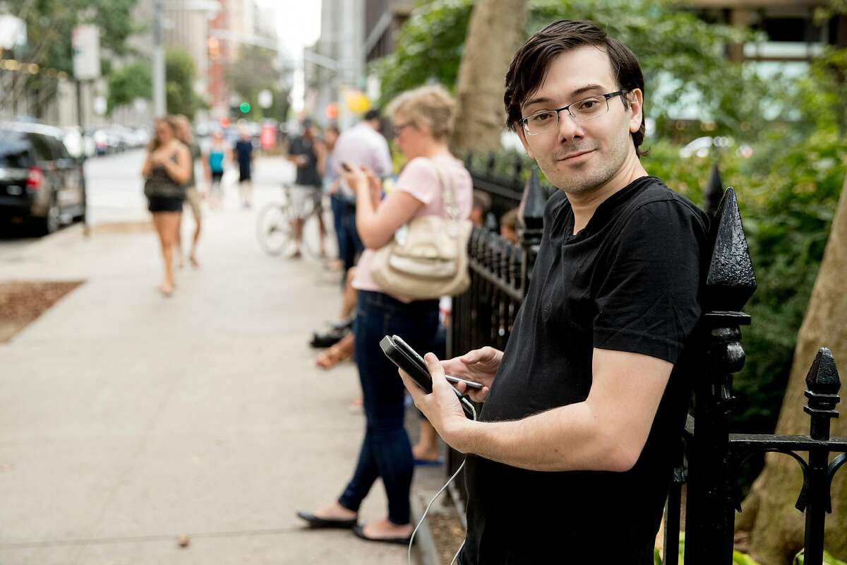 Former Turing Pharmaceuticals CEO Martin Shkreli, who said he was reporting using a video service called "periscope" on his smartphone, stands with reporters after Democratic presidential candidate Hillary Clinton leaves an apartment building Sunday, Sept. 11, 2016, in New York. Following his ban from Twitter earlier this week, Shkreli will take part in a talk with Breitbart editor Milo Yiannopoulos on Friday at UC Davis.