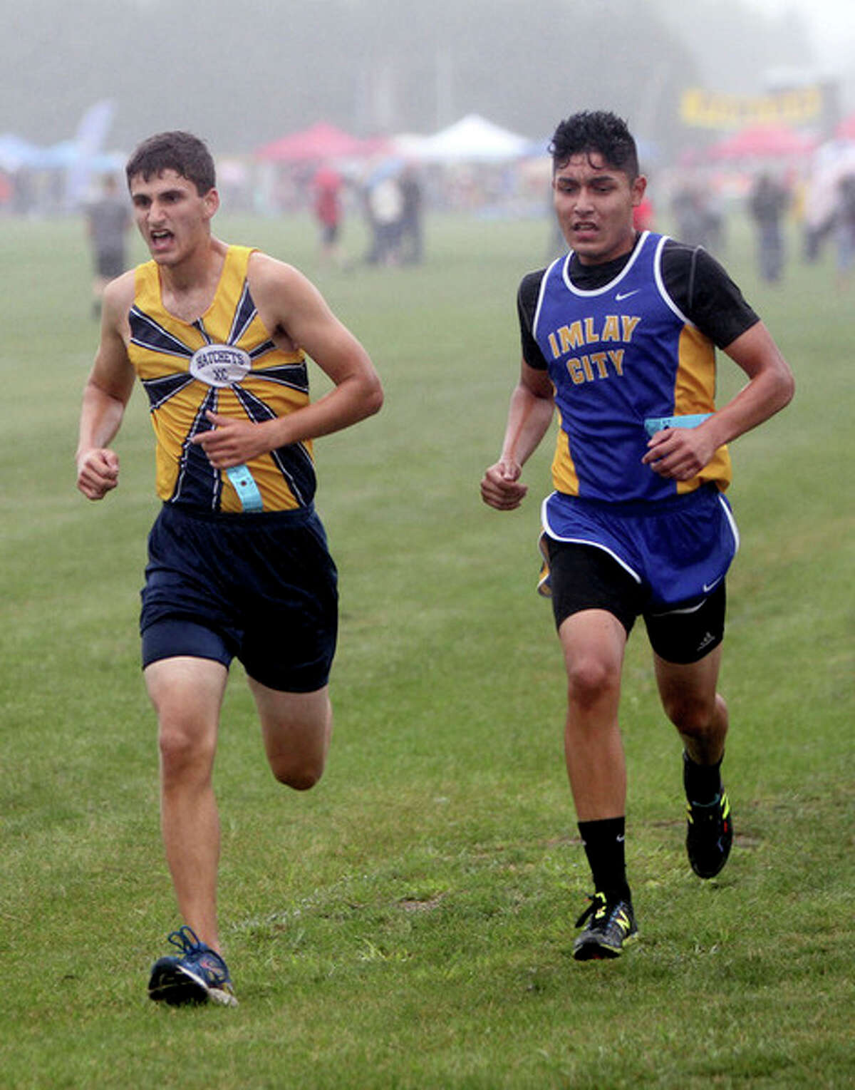 Bad Axe's Kendal Delpiere is side by side with Imlay City's Raul Rodriguez.