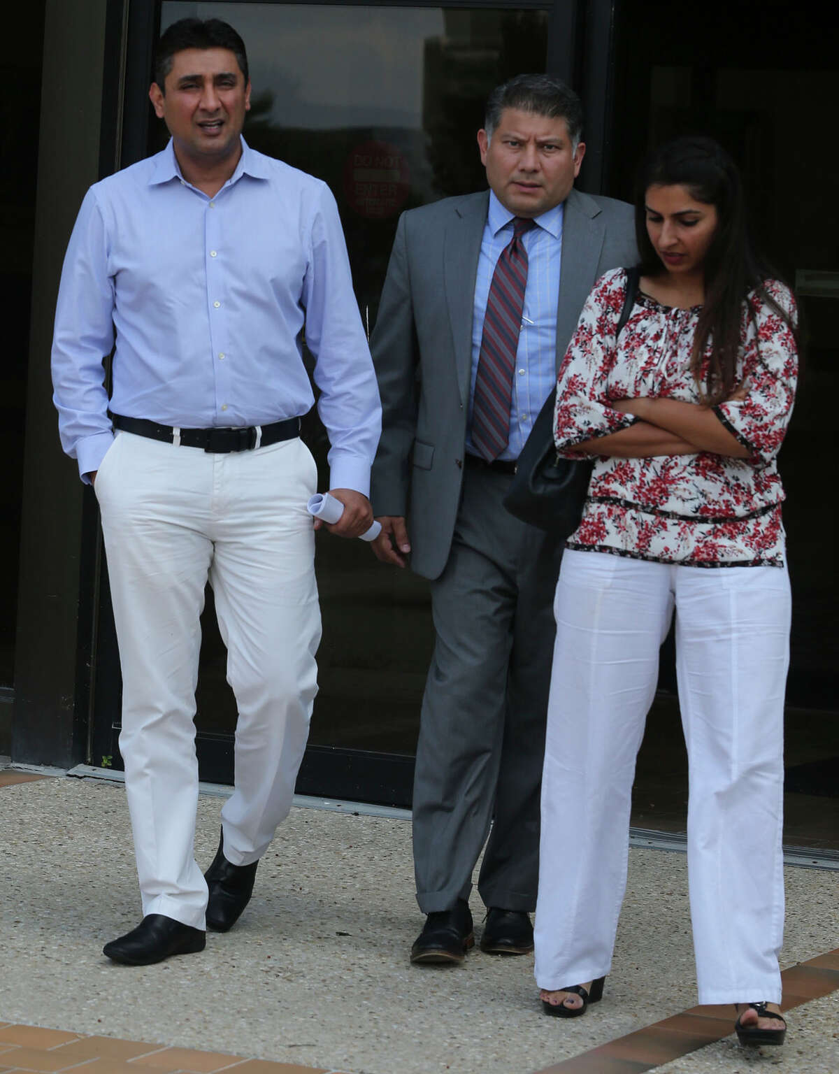Azeez Mistry (left) leaves San Antonio’s federal courthouse. Mistry is to be sentenced Dec. 7 for bribing a fellow worker to document undocumented immigrants as citizens.