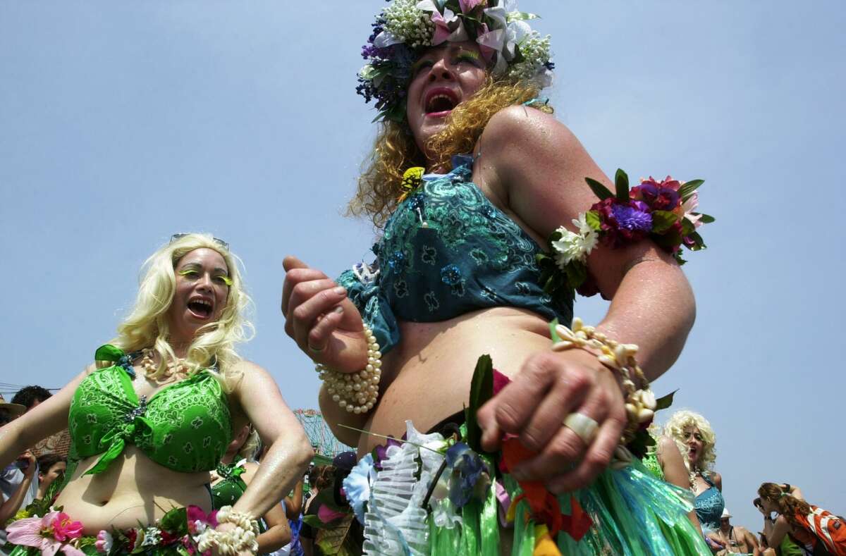 UNITED STATES - CIRCA 2002: Hawaiian-style mermaids dance down the boardwalk during the annual Mermaid Parade in Coney Island. (Photo by Linda Rosier/NY Daily News Archive via Getty Images)