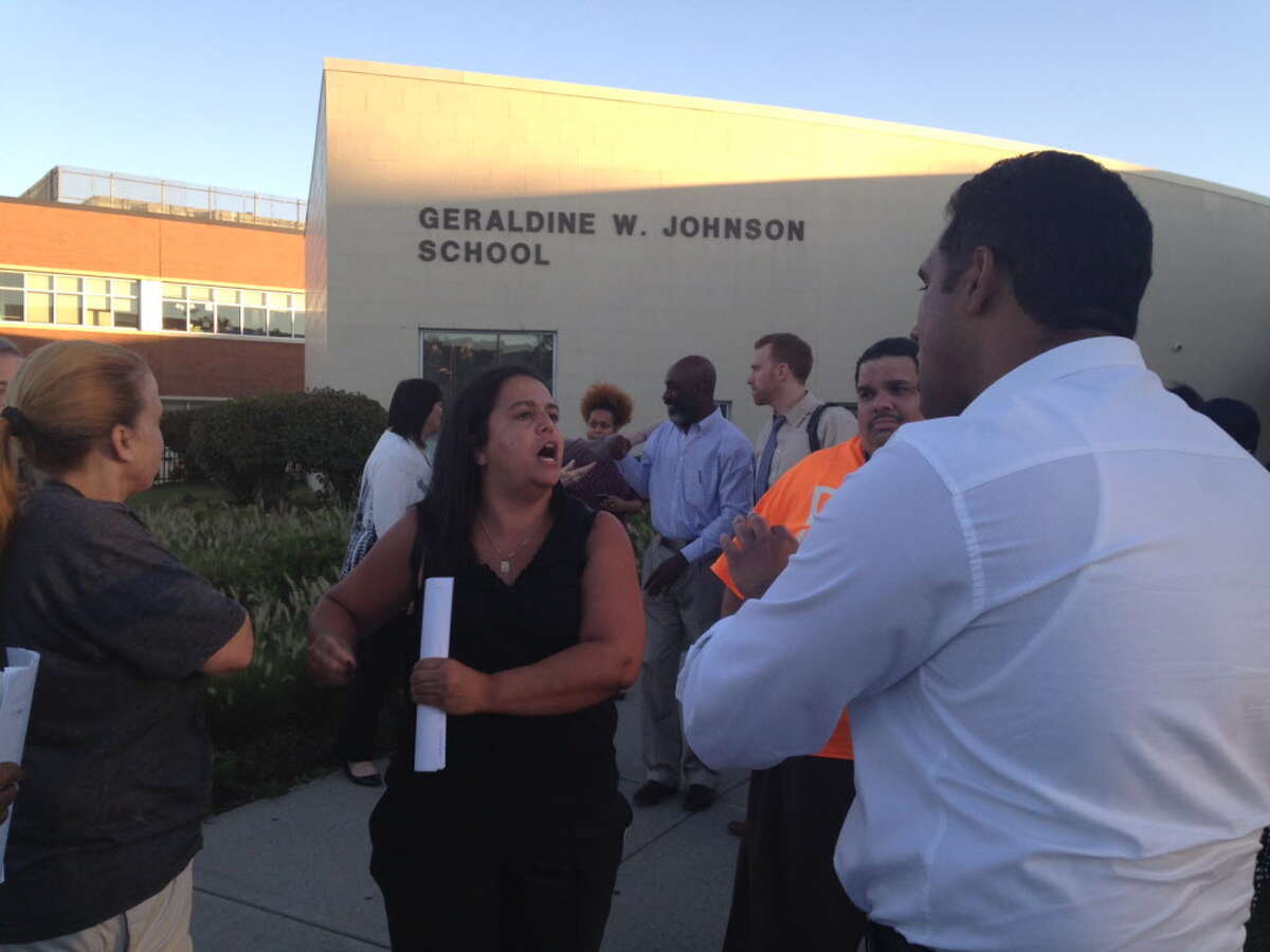 Bridgeport BOE chairman Dennis Bradley is confronted by angry parents outside Johnson School. September 12, 2016