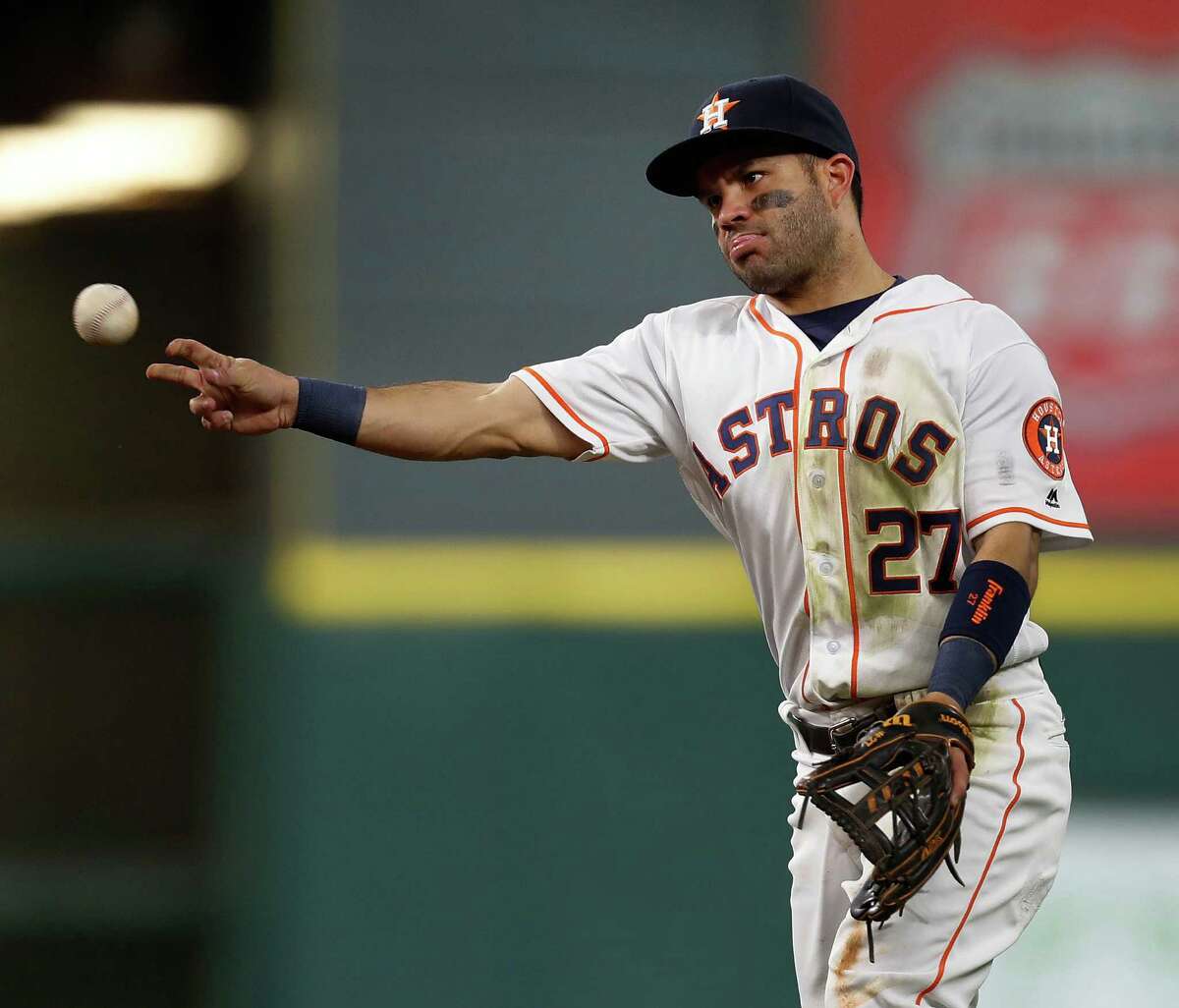 Houston Astros second baseman Jose Altuve (27) throws to first as Texas Rangers Mitch Moreland grounded out during the third inning of an MLB game at Minute Maid Park, Monday, Sept. 12, 2016 in Houston.