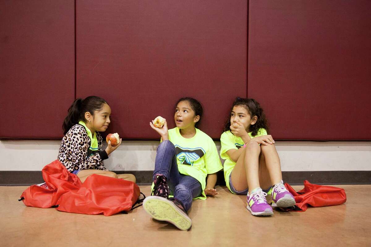 This 2015 file photo shows students snacking on apples at the George Gervin Academy, a charter school. It appears the NAACP is painting all charter schools with an unfair broad brush.