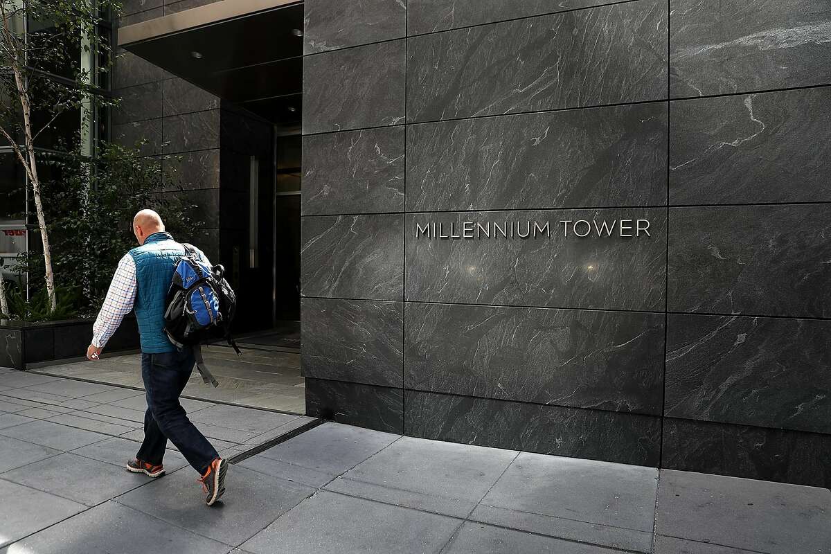 SAN FRANCISCO, CA - AUGUST 11: A person walks by the Millennium Tower on August 11, 2016 in San Francisco, California. A $500 million lawsuit has been filed against building owner the owner of the Millennium Tower, Millennium Partners, and the Transbay Joint Powers Authority after it was revealed that the building had sunk 16 inches into the ground and is leaning two inches to the northwest. The 58-story, 419-residence building was completed in 2009. (Photo by Justin Sullivan/Getty Images)