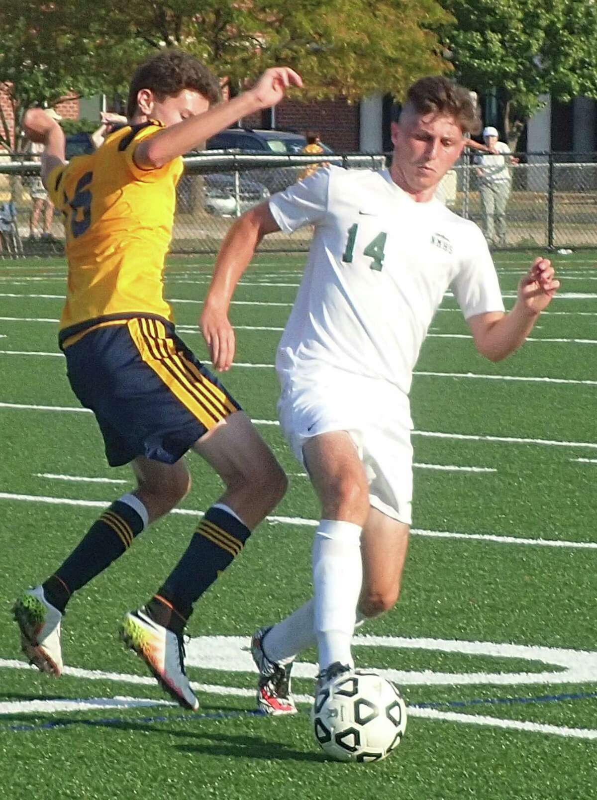 New Milford's Shane Fedigan, right, battles for possession of the ball with Weston's Sam Chicha defends during their soccer game at New Milford High School Sept. 13, 2016.