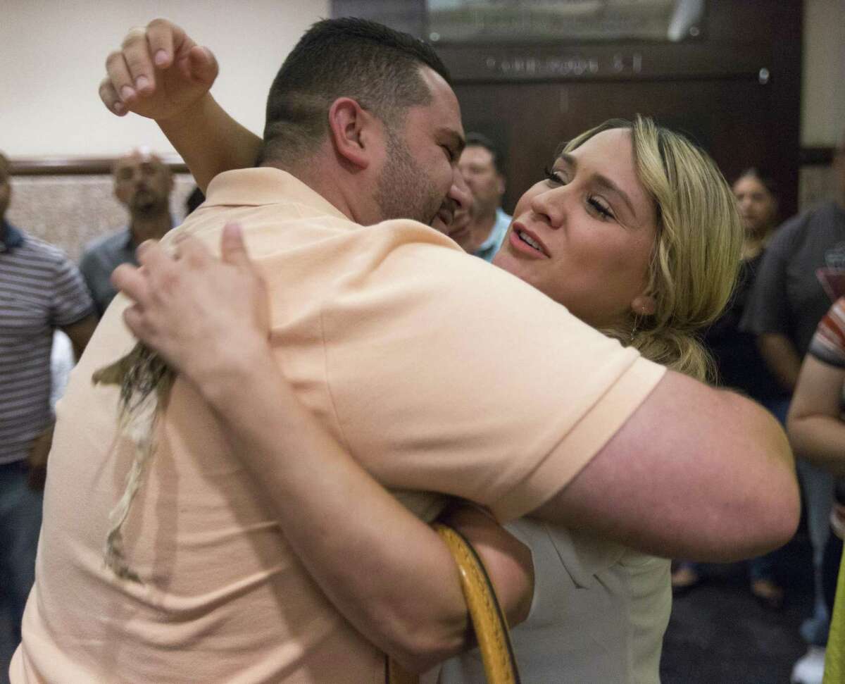 Justin, left, and sister Dominique Hall hug Thursday, Sept. 13, 2016 after their mother Frances Hall was sentenced to 2 years in prison for the murder of her husband and Justin's and Dominique's father. Hall was convicted last week of killing her husband, trucking tycoon Bill Hall, in 2013 by running his motorcycle off the road with her Cadillac SUV.