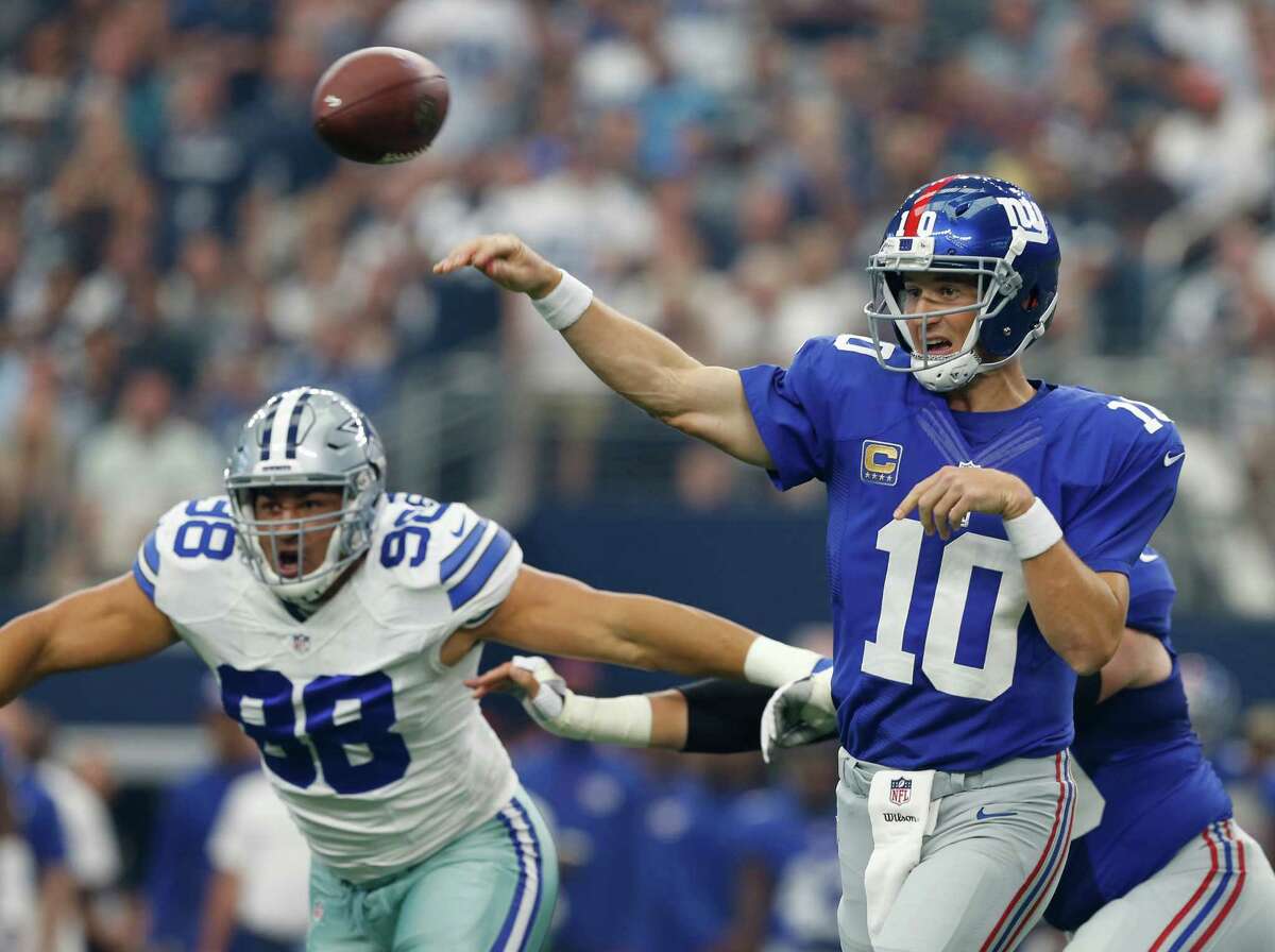 New York Giant quarterback Eli Manning throws down field as Dallas Cowboy's Tyrone Crawford defends during the first half of an NFL football game at AT&T Stadium, Sunday, Sept. 11, 2016, in Arlington, Texas. (Jose Yau/Waco Tribune Herald via AP) ORG XMIT: TXWAC101