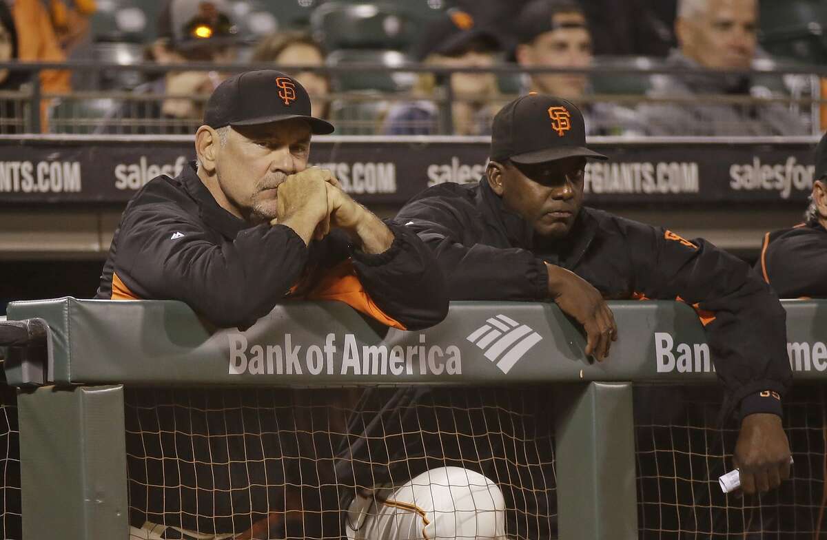 San Francisco Giants manager Bruce Bochy, left, and hitting coach Hensley Meulens, right, watch from the dugout in the ninth inning of a baseball game against the San Diego Padres Monday, Sept. 12, 2016, in San Francisco. San Diego won the game 4-0.