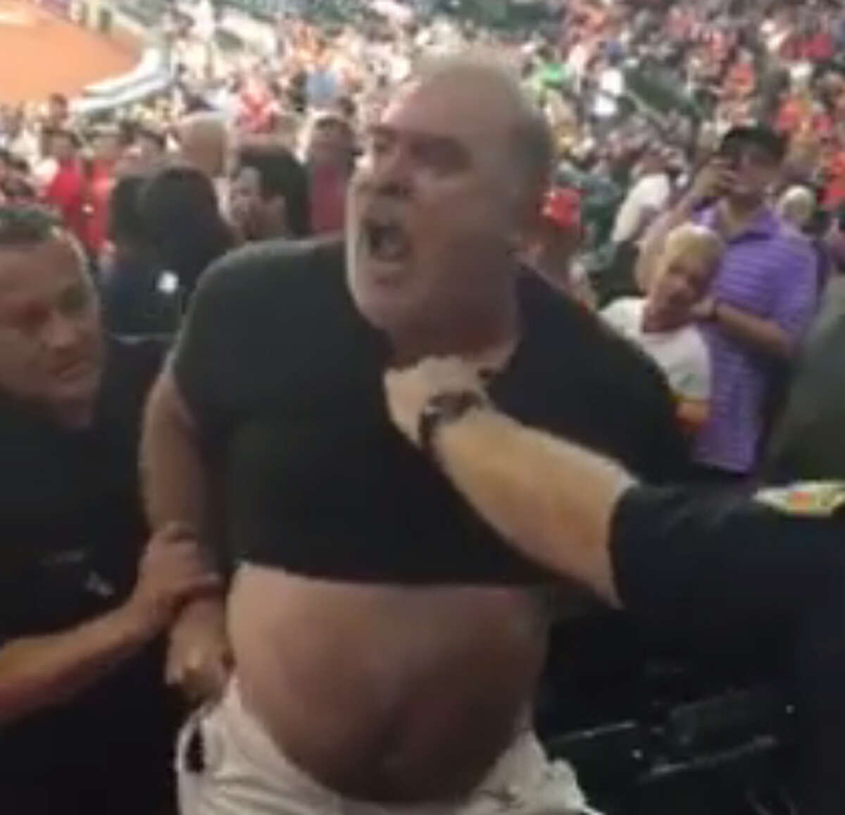 A fan at Monday night's Astros-Rangers game had a few choice words for the Rangers as he was handcuffed and escorted from Minute Maid Park.
