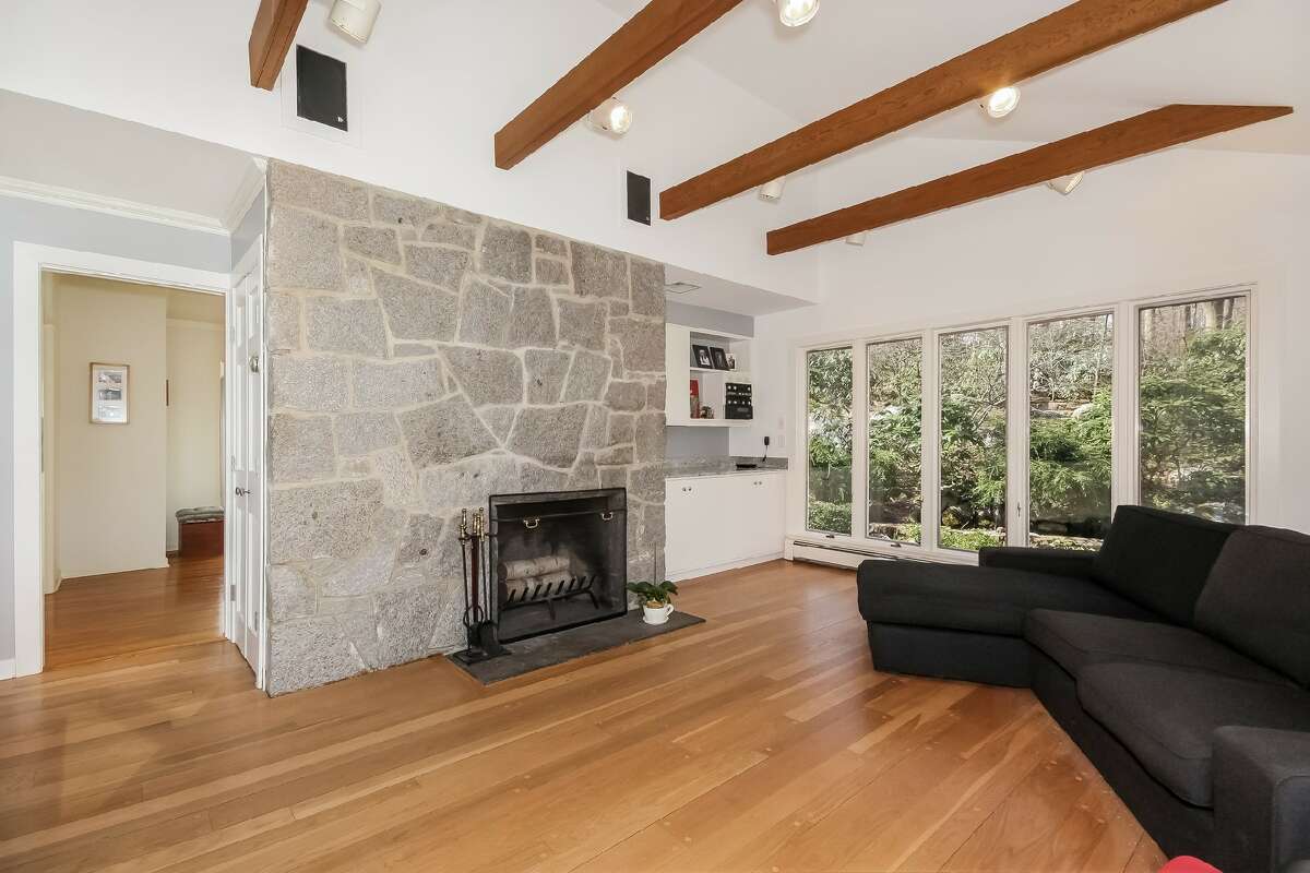 The second of the home’s two fireplaces is in the family room— this one is stone.