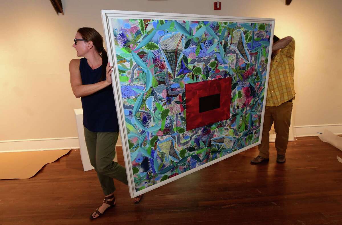 Silvermine Arts Center Gallery Manager, Jennifer Burbank, and Gallery Director, Jeffrey Mueller, install the new exhibit, Flow, including an acrylic and mixed media work by Charles Geiger, Grey Rhizome, Tuesday. September, 13, 2016.