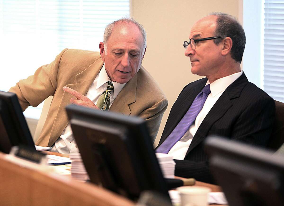 Board president Victor Makras (left) and commissioner Herb Meiberger (right) of the San Francisco Employees' Retirement Slystem listen to retirees before voting on the proposal to invest up to 15 percent of the portfolio in hedge funds in San Francisco, Calif., on Wednesday, December 3, 2014.