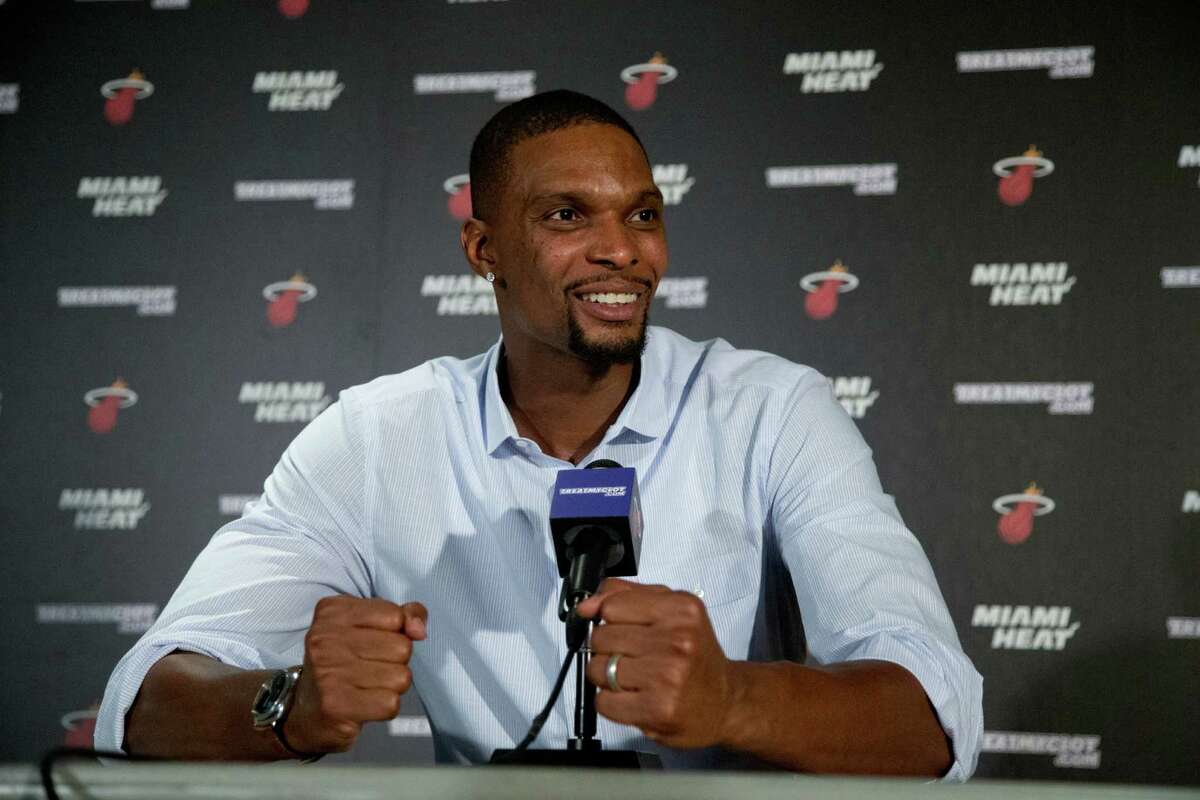 FILE - In this Sept. 24, 2015, file photo, Miami Heat forward Chris Bosh gestures as he speaks during a news conference, in Miami. The Heat forward who had each of his last two seasons halted by blood clots that were discovered at the All-Star break said in a podcast released Wednesday, Sept. 14, 2016, that he "absolutely" intends to be with his team for training camp that starts in the Bahamas on Sept. 27. But he also revealed that he has not yet been cleared to play again, though he's confident that it will happen. (AP Photo/Wilfredo Lee, File) ORG XMIT: NY174