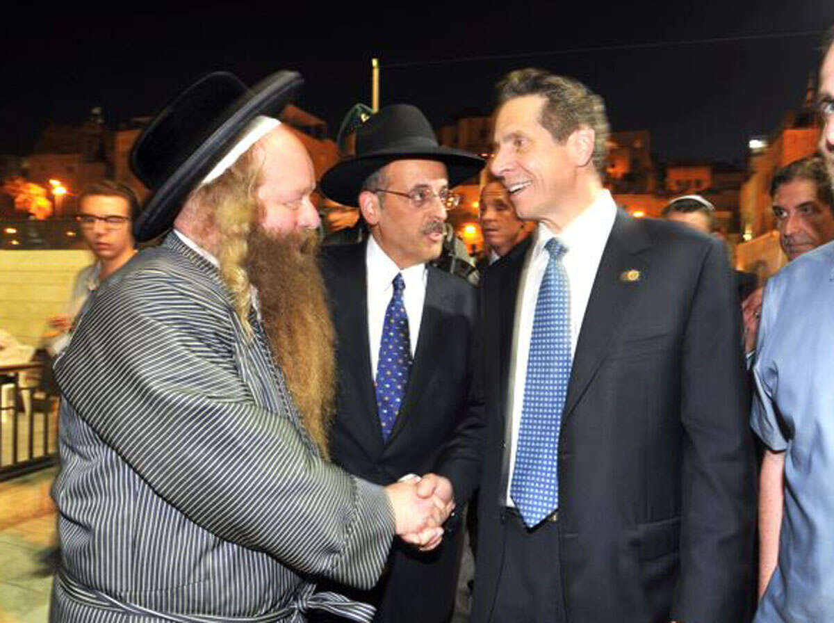 Abraham Eisner, center, introduced Gov. Cuomo, right, to an unidentified man during a visit to the Church of the Holy Sepulchre and the Western Wall in Jerusalem on Aug. 13, 2014. (Office of the Governor)