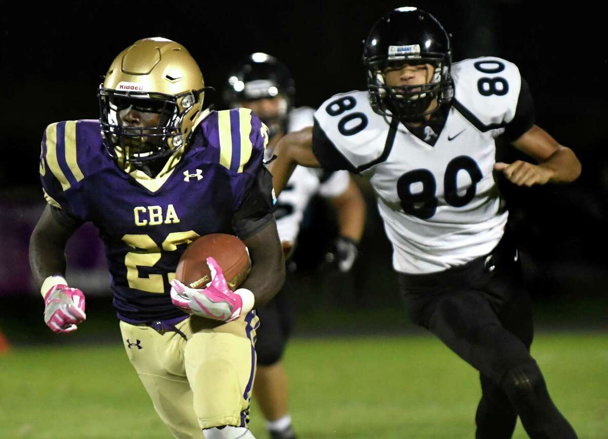 CBA's Taurian Taylor, left, carries the ball as Albany's Phillip Williams defends during their football game on Friday, Sept. 9, 2016, at Christian Brothers Academy in Colonie, N.Y. (Cindy Schultz / Times Union)