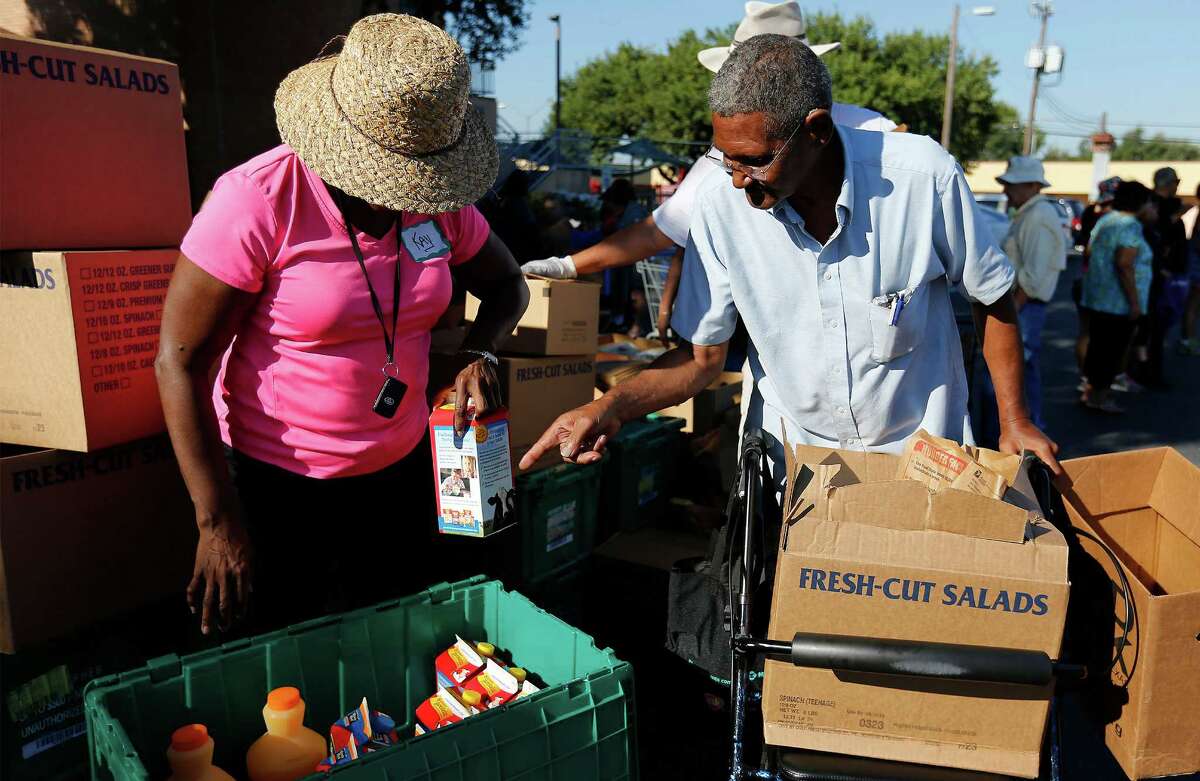 Charles Pate, 72, decides what kind of juice he wants while picking up food at Windcrest United Methodist Church on Thursday, Sept. 15, 2016. Once a month, the church serves as a pickup location for people in need of food. Through funding from the Texas Diaper Bank, the church provides a location and manpower for the San Antonio Food Bank to drop off nutritional foods to be distributed to about 100 households. Nearly 30 volunteers gathered to help distribute the food to recipients like Pate. The Vietnam veteran said he has come out to the Windcrest church to get food for the past three to four years. The supply usually lasts about two weeks, Pate said.