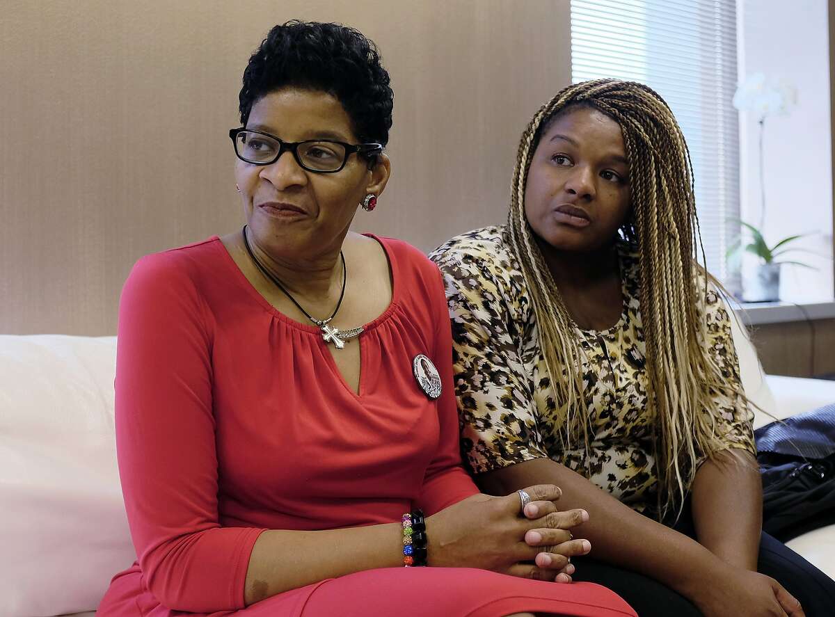 Geneva Reed-Veal, left, mother of Sandra Bland, a black Chicago-area woman who died in a Texas jail after a contentious traffic stop last summer, waits with her daughter Shavon Bland in the family's attorney's office, Thursday, Sept. 15, 2016, in Chicago. Bland died in her cell at the Waller County Jail three days after she was arrested by a white Texas state trooper for a minor traffic offense in July 2015. Her death was ruled a suicide, and Bland's family later sued the county and the Texas Department of Public Safety. (AP Phoro/Kiichiro Sato)