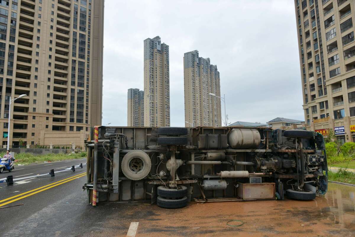 An overturned truck is seen on a street in Xiamen, China's eastern Fujian province, after Typhoon Meranti made landfall on September 15, 2016. Typhoon Meranti made landfall in Fujian early September 15 with winds up to 230kph, knocking out electricity in some areas and causing rail delays. / AFP / STR / China OUT (Photo credit should read STR/AFP/Getty Images)