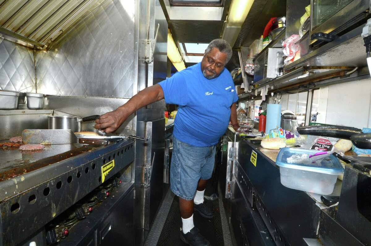 Herb Edmondson, Owner, fills some lunch orders on a busy Thursday September 15, 2016 at his food truck, Herb's Place in Norwalk, Conn. Herb's Place is listed in the business directory on ctblackowned.com, which is merging with shopblackct.com. Thompson, an Avon resident who is the senior marketing and communications director at a nonprofit in Hartford called The Village for Families and Children, said she started the site as a way to provide marketing resources to Black businesses in Connecticut. One way the site is doing this is through a blog section for which professional photographers volunteer to shoot photos of the businesses to accompany volunteer-written articles. The photographs are gifted to the business owners free of charge so they can be used for promotional material.   Yvette Young of Windsor, who works with Thompson at The Village for Families and Children as the VP of programs and advocacy, joined the project early on. She said the marketing piece is what sets them apart from other business listings in the state.  