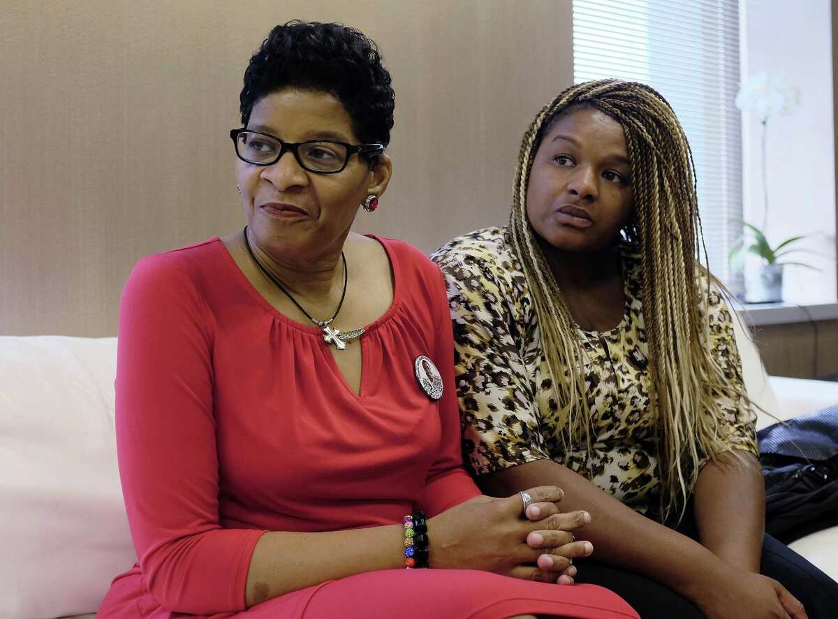 Geneva Reed-Veal, left, mother of Sandra Bland, a black Chicago-area woman who died in a Texas jail after a contentious traffic stop last summer, waits with her daughter Shavon Bland in the family's attorney's office, Thursday, Sept. 15, 2016, in Chicago. Bland died in her cell at the Waller County Jail three days after she was arrested by a white Texas state trooper for a minor traffic offense in July 2015. Her death was ruled a suicide, and Bland's family later sued the county and the Texas Department of Public Safety. (AP Phoro/Kiichiro Sato)