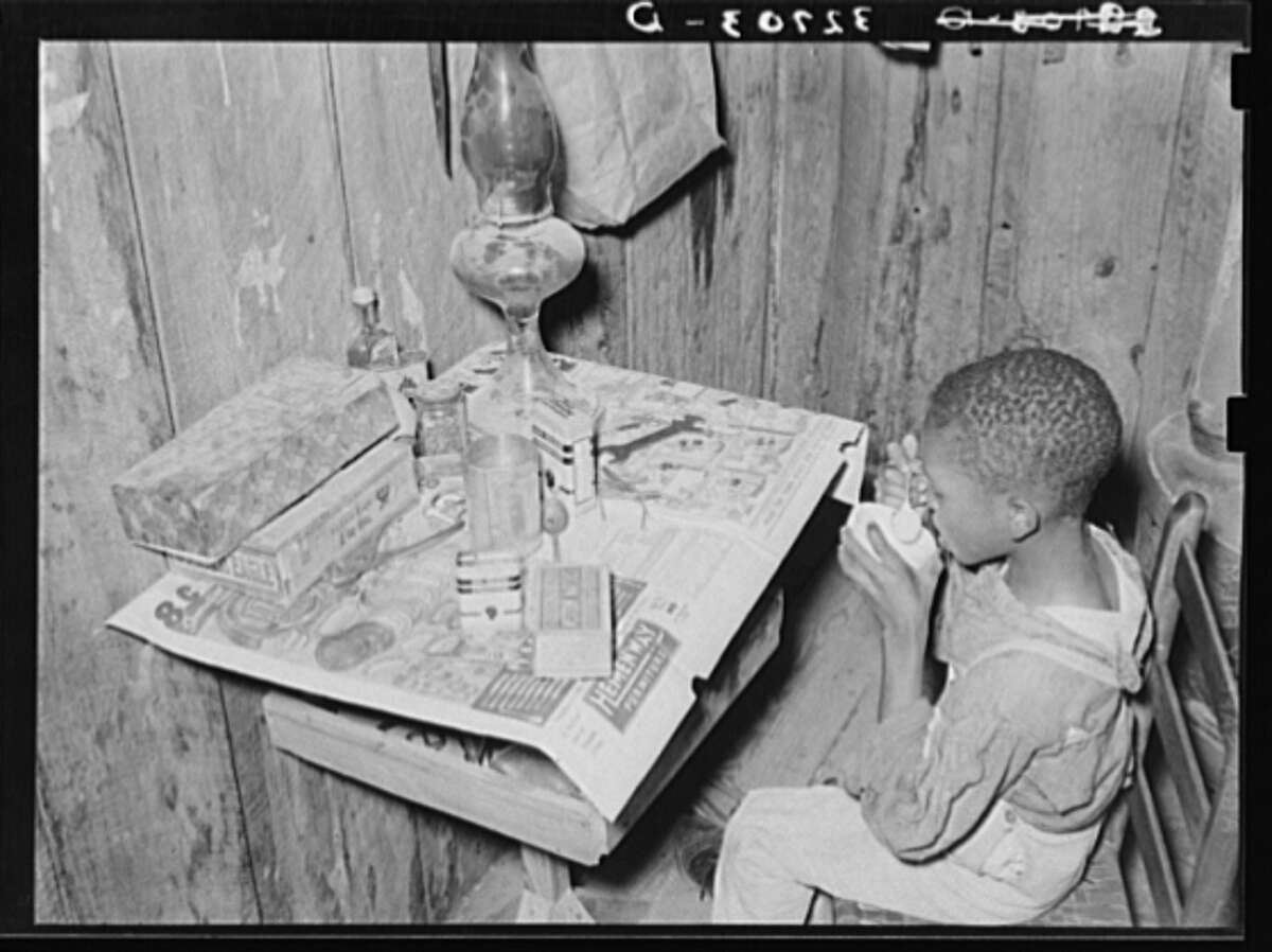 Flour and water passed as "milk." Original description: "Boy drinking 'milk' made of flour and water. He was sick and his mother, the wife of a sharecropper, had given him this as a delicacy." Date: March 1939.