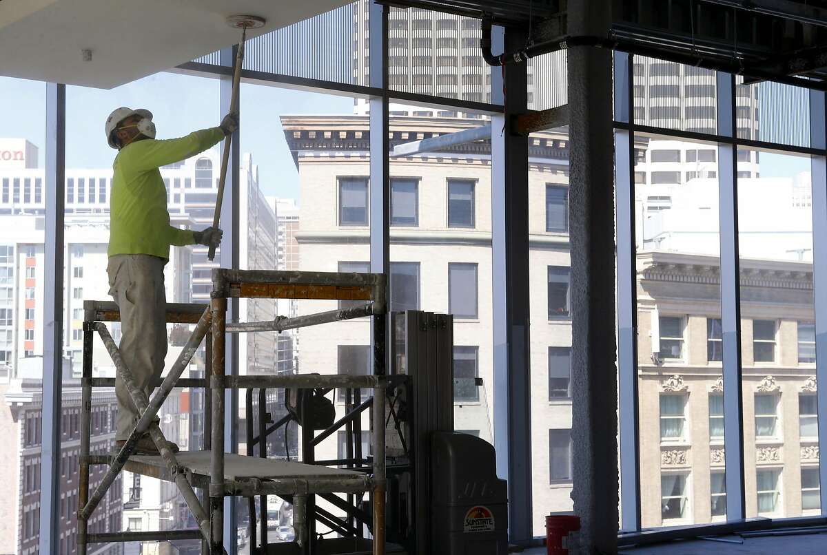 A worker sands a section of ceiling in front of the full length windows at the 6x6 shopping mall under construction in San Francisco, Calif. on Thursday, Sept. 15, 2016. Developers are renaming the project from its original Market Street Place and are refocusing the marketing strategy in an effort to attract retail tenants to the mid-Market site between 5th and 6th streets.