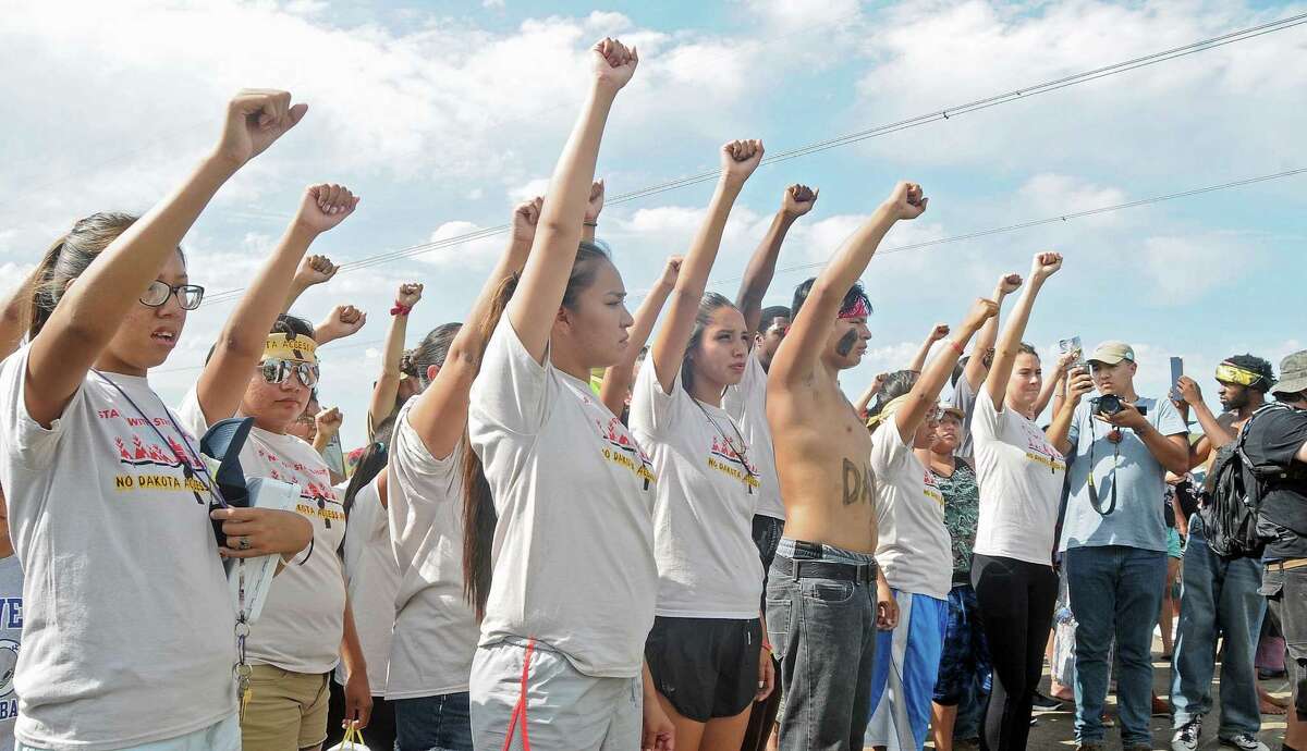 People against the Dakota Access Pipeline chant in opposition on Thursday, Aug. 11, 2016, at a site where a roadway was being constructed to begin the process of building the pipeline. The pipeline would start in North Dakota and pass through South Dakota and Iowa before ending in Illinois. Construction of the pipeline began this week just north of the Standing Rock Sioux reservation. (Tom Stromme/The Bismarck Tribune via AP)