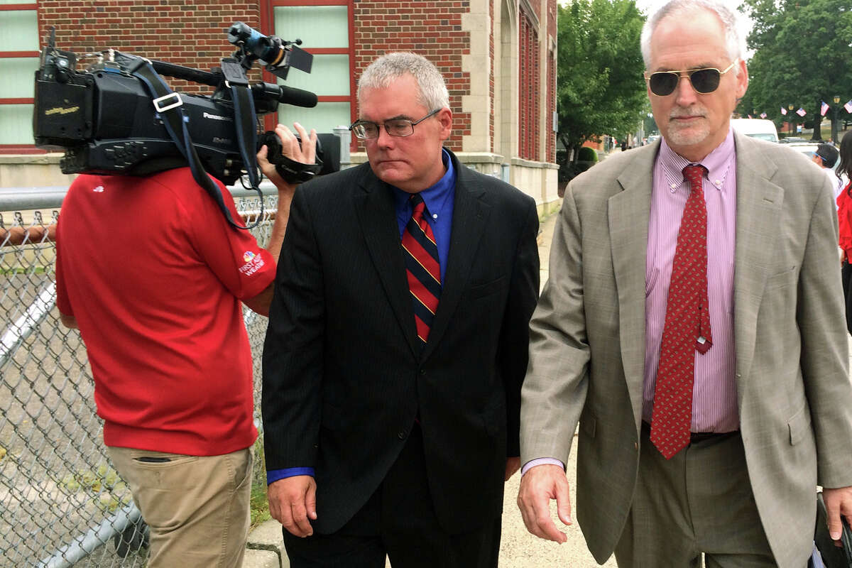 Peter Kruzynski, center, leave the Derby courthouse Aug. 31, 2016. Kruzynski, 49, of Shelton, was arrested Tuesday on charges of first-degree sexual assault, second-degree sexual assault, fourth-degree sexual assault, two counts of risk of injury to a minor and impairing the morals of a minor and coercion. Kruzynski is seen here with attorney Eugene Riccio, right.