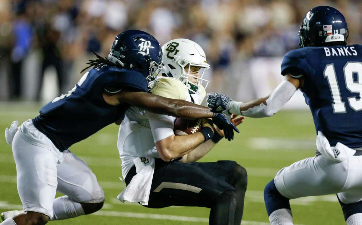 Rice safety Destri White (6) and cornerback V.J. Banks (19) stop Baylor quarterback Seth Russell (17) after a short gain during the second quarter of an NCAA football game at Rice Stadium on Friday, Sept. 16, 2016, in Houston.