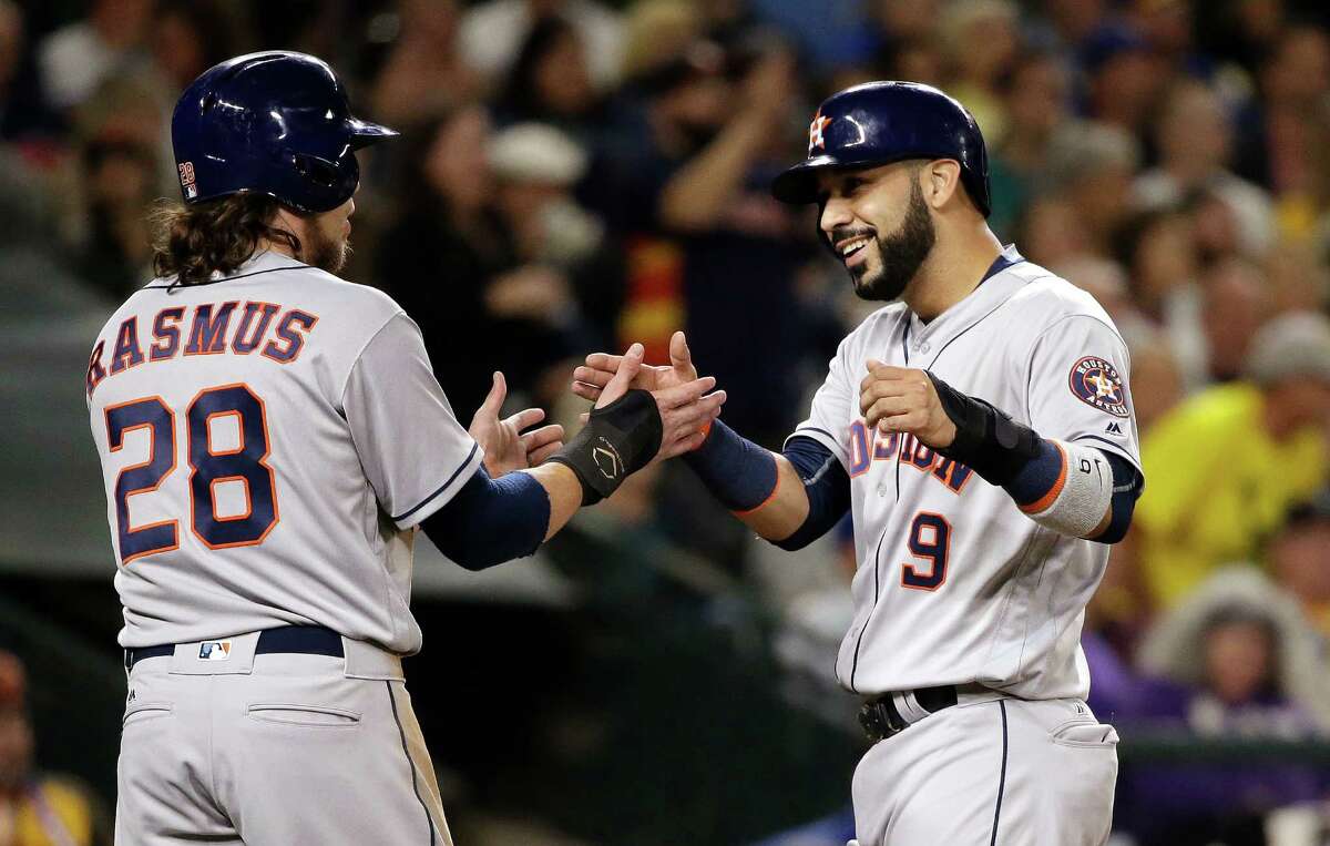 Houston Astros' Colby Rasmus (28) greets Marwin Gonzalez at home after both scored against the Seattle Mariners during the second inning of a baseball game Friday, Sept. 16, 2016, in Seattle. (AP Photo/Elaine Thompson)