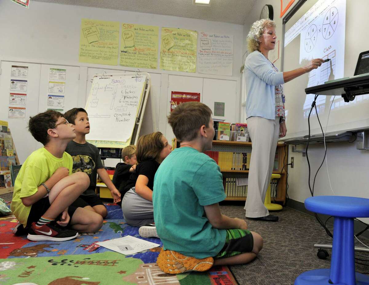 Fourth-grade teacher Pam Lucchesi leads the class in a math exercise at Booth Free School in Roxbury.