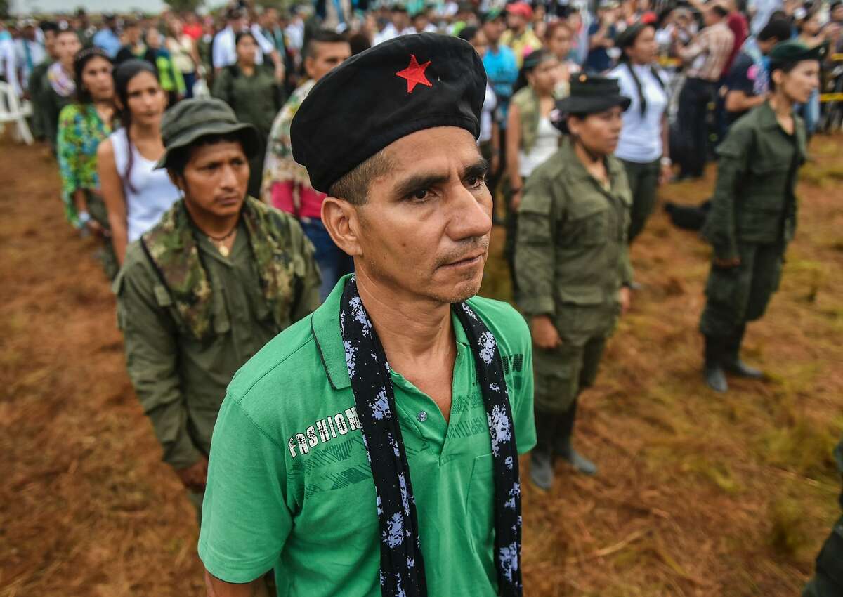Members of the Revolutionary Armed Forces of Colombia (FARC) attend the opening ceremony of the September 17-23 10th National Guerrilla Conference at the camp in Llanos del Yari, Caqueta department, Colombia, on September 17, 2016. After 52 years of armed conflict, FARC rebels open what leaders hope will be their last conference as a guerrilla army, where they are due to vote on a historic peace deal with the Colombian government. / AFP PHOTO / LUIS ACOSTALUIS ACOSTA/AFP/Getty Images
