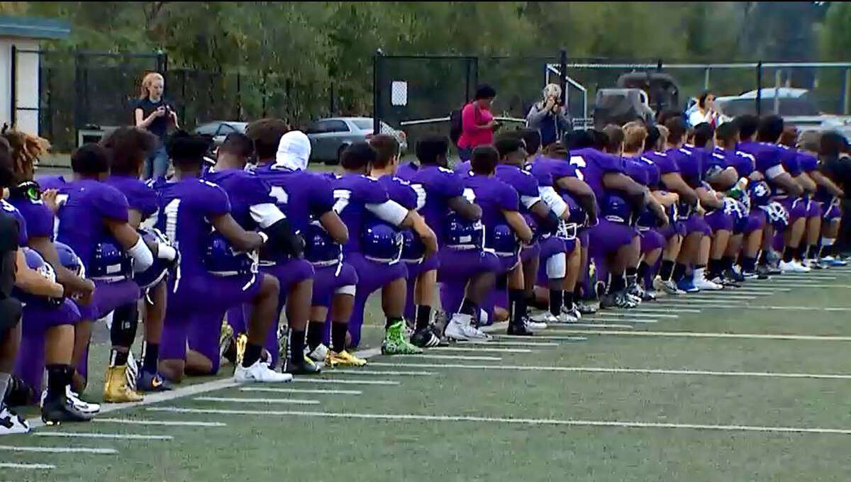 Seattle's Garfield High School football team kneels during national anthem