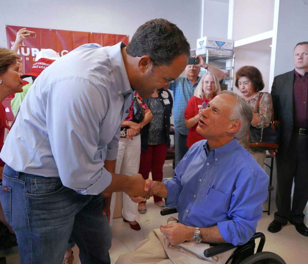 U.S. Rep. Will Hurd of San Antonio, left, greets GOP Texas Gov. Greg Abbott at Hurd's campaign headquarters near Loop 1604 at Huebner on Saturday. Abbott told supporters the race against challenger Pete Gallego has national importance.