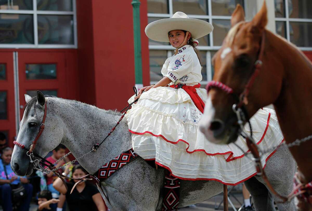 Emily Ayala, 9, of Las Coronelas de San Antonio rides her horse as she takes part in the Avenida Guadalupe neighborhood Diez y Seis de Septiembre Parade on Saturday, Sept. 17, 2016. Hundreds of parade watchers lined the streets on the city's Westside as about 60 floats, marchers and bands cruised through to celebrate Mexico's independence from Spain. Food, music and presentations followed throughout the day at Plaza de Guadalupe. (Kin Man Hui/San Antonio Express-News)