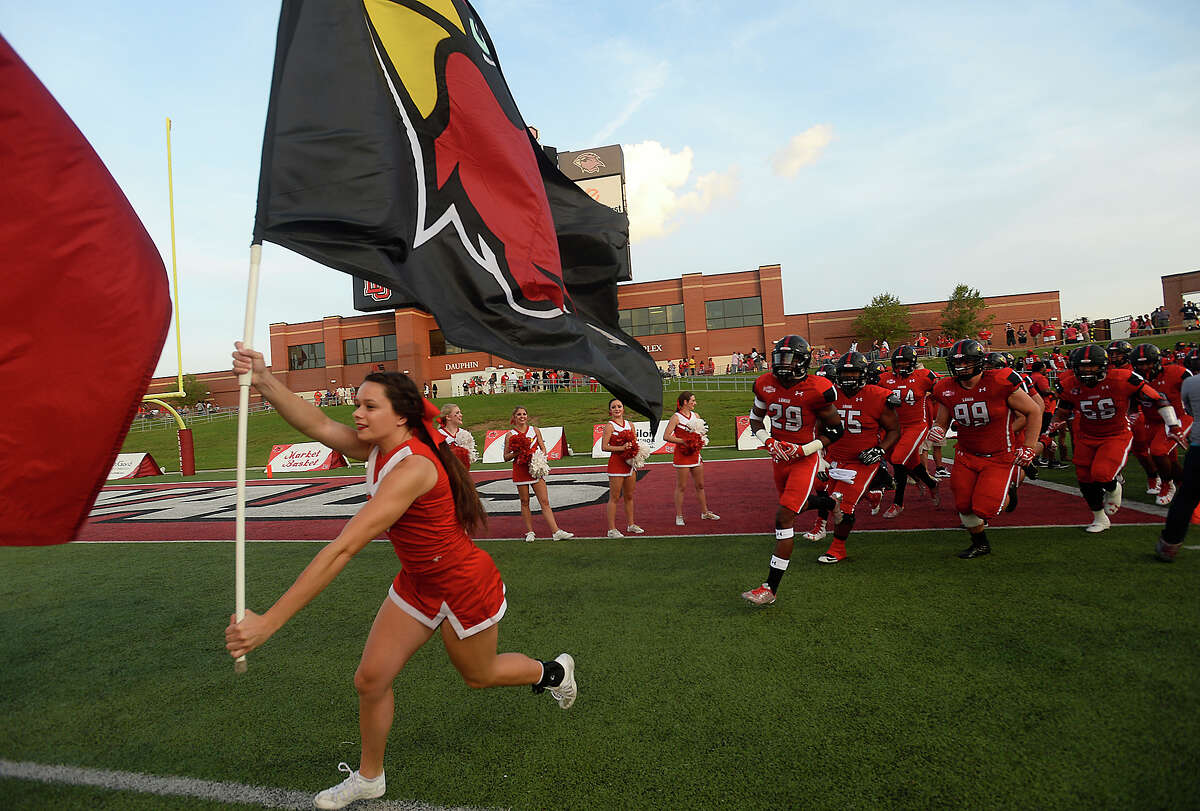 Lamar's cheerleaders lead the charge into the stadium as they get ready for the start of game action against Sam Houston State Saturday at Provost-Umphrey Stadium. Photo taken Saturday, September 17, 2016 Kim Brent/The Enterprise