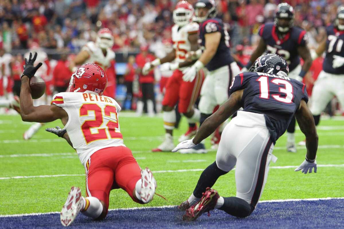 Kansas City Chiefs cornerback Marcus Peters (22) intercepts a pass intended for Houston Texans wide receiver Braxton Miller (13) during the first quarter of an NFL game at NRG Stadium Sunday, Sept. 18, 2016 in Houston.