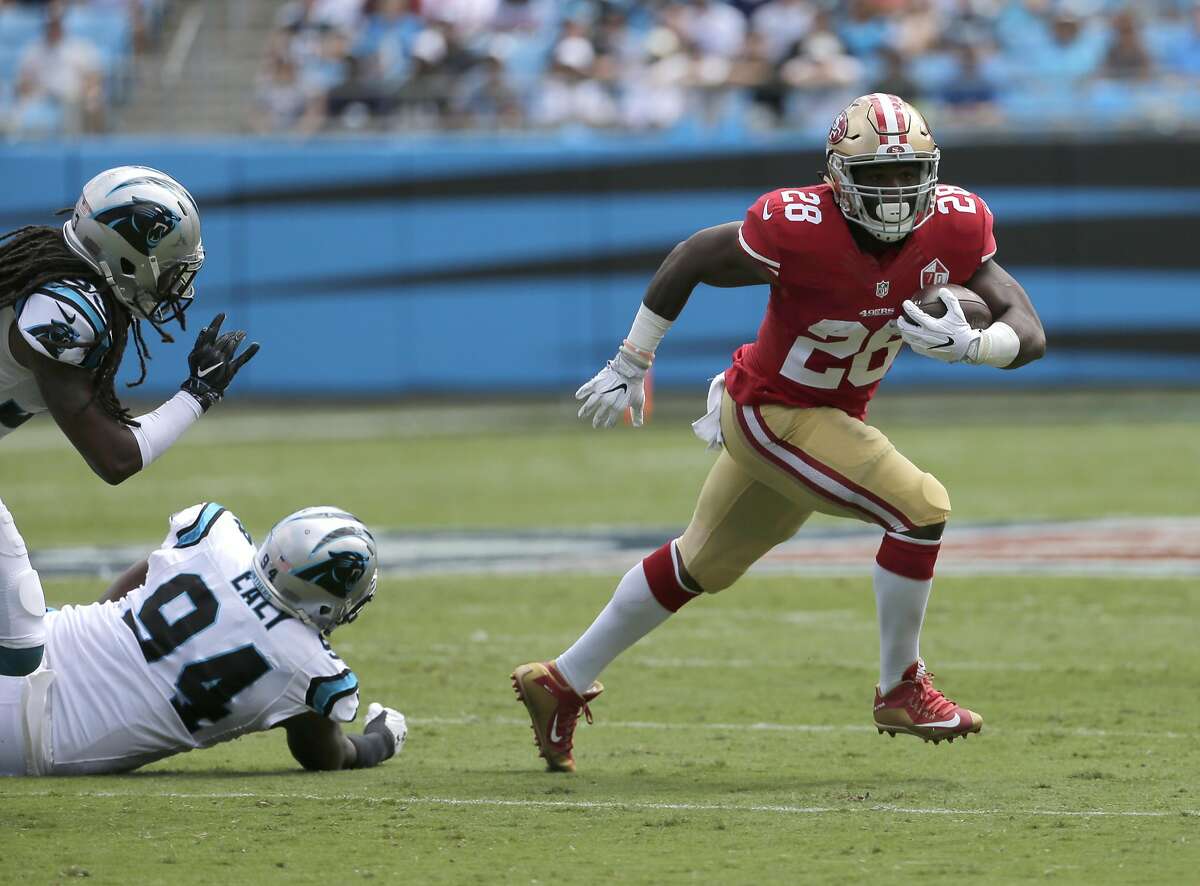 San Francisco 49ers' Carlos Hyde (28) runs against the Carolina Panthers in the first quarter of an NFL football game in Charlotte, N.C., Sunday, Sept. 18, 2016. (AP Photo/Chuck Burton)