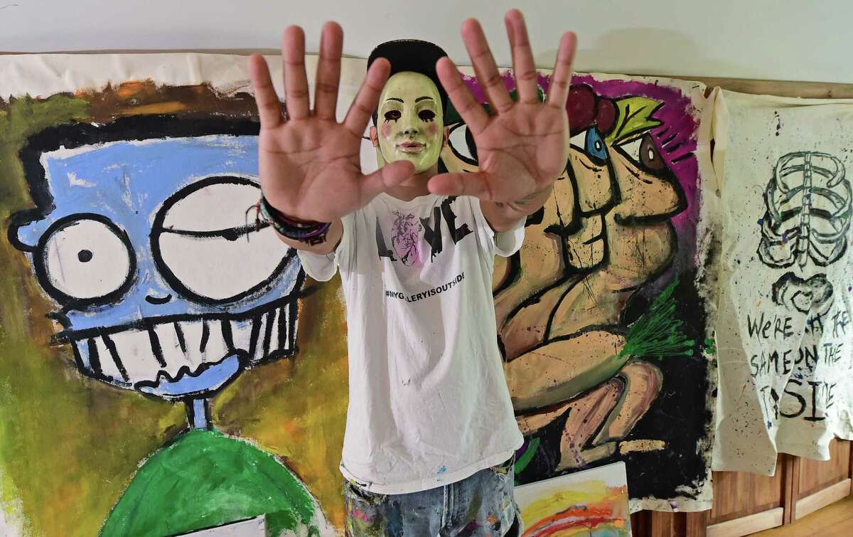 Norwalk resident, The artist known as 5iveFingaz in his Norwalk, Conn. studio Friday, September, 9, 2016. 5iveFingaz is an artist/musician that creates art and leaves it in public spaces for people to find while remaining anonymous. He promotes his work under the pseudonym 5iveFingaz on Instagram and on his website mygalleryisoutside.com.
