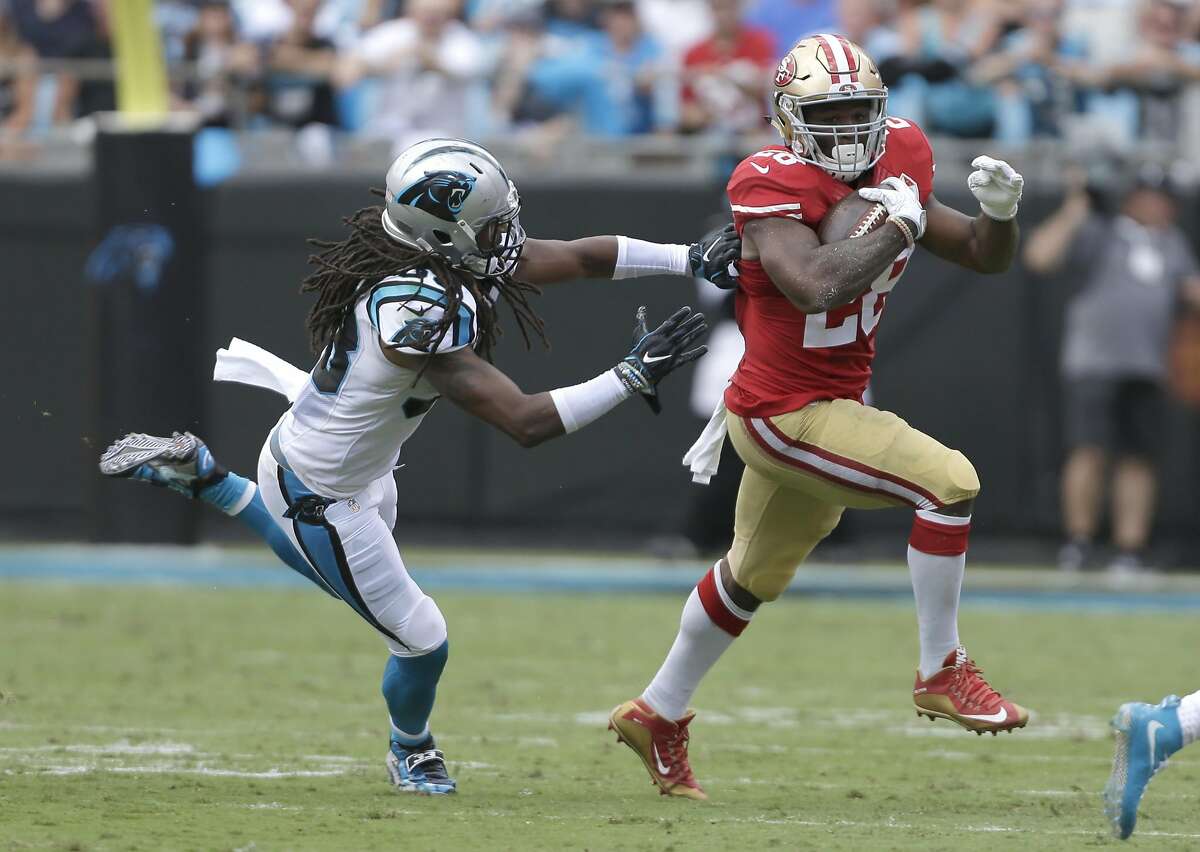 San Francisco 49ers' Carlos Hyde (28) runs as Carolina Panthers' Tre Boston (33) defends in the first quarter of an NFL football game in Charlotte, N.C., Sunday, Sept. 18, 2016. (AP Photo/Bob Leverone)
