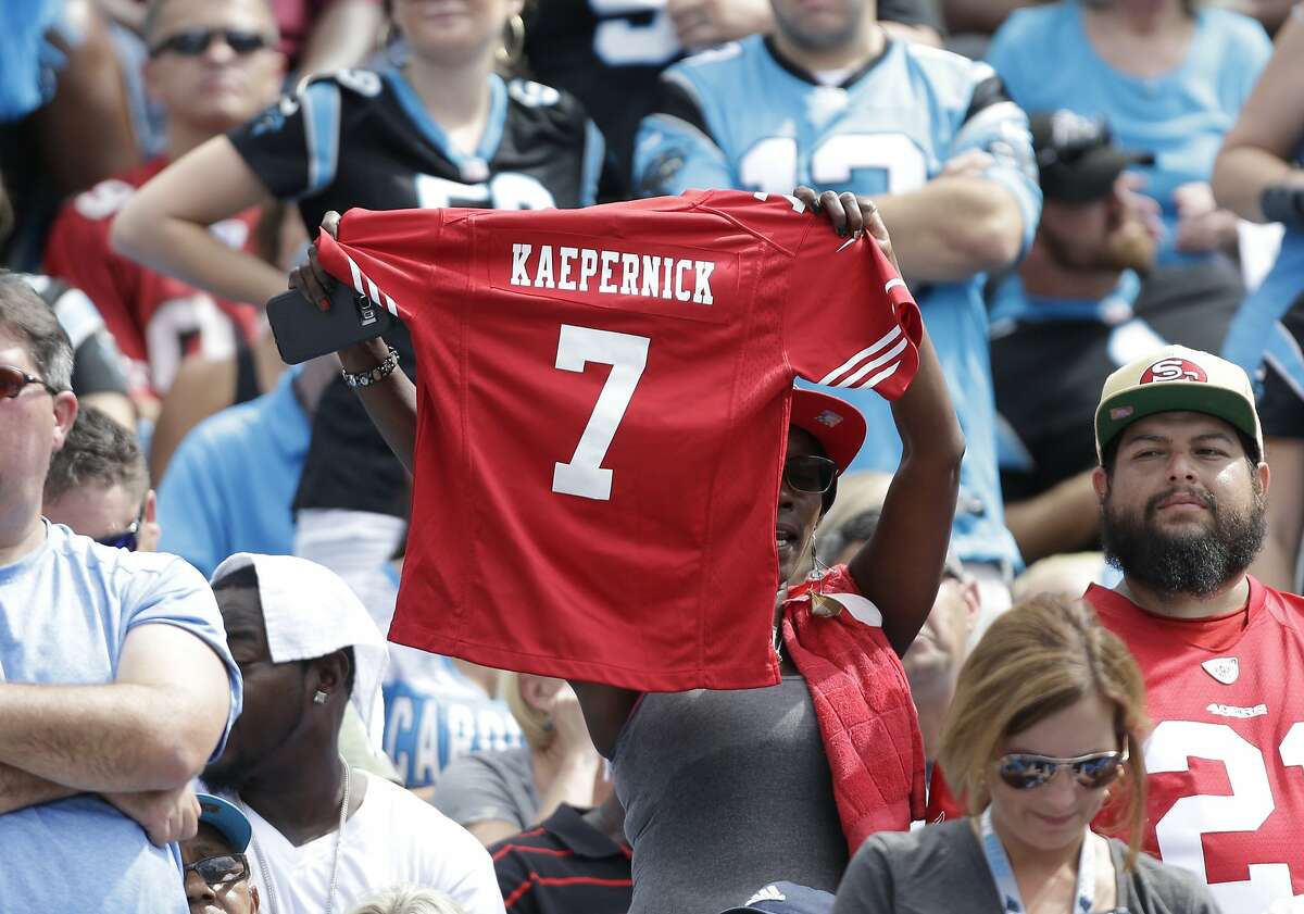 A San Francisco 49ers fan holds up a Colin Kaepernick jersey in the first half of an NFL football game against the Carolina Panthers in Charlotte, N.C., Sunday, Sept. 18, 2016. (AP Photo/Bob Leverone)